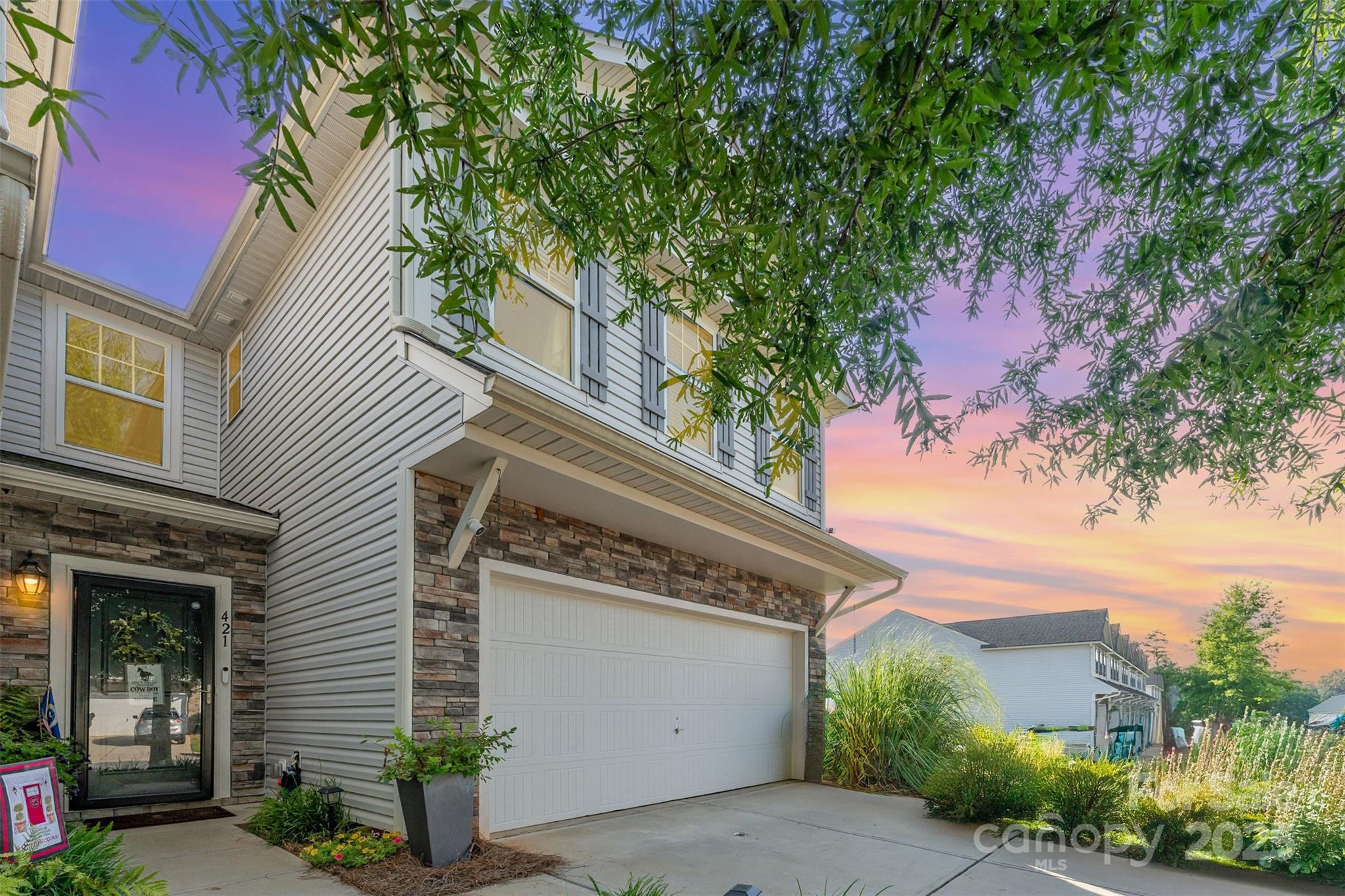This fully custom end-unit home sits between two cul-de-sacs in the desirable Regent Park neighborhood of Fort Mill! Inside, you'll find a bright, open layout filled w/ natural light & custom details throughout—shiplap & custom millwork walls, crown molding, painted (2022), newer laminate flooring on main floor & premium carpet upstairs, glass storm door, designer lights & so much MORE!  The open concept living room is centered by the brick fireplace w/ wood mantle & built-ins. The kitchen offers granite countertops, open wood shelving, wood shelved pantry & SS appliances (2022). The main level also features a stylish half bath w/ a custom vanity & a functional drop zone w/ wood shelving. Upstairs, you'll find the spacious living area that creates the perfect split bedroom floorplan. Outside, enjoy an expanded back patio & rare grassy sideyard. Don't miss the spacious 2-car garage + spacious driveway! Located in a top-rated school district and easy access to shopping, dining, and I-77!