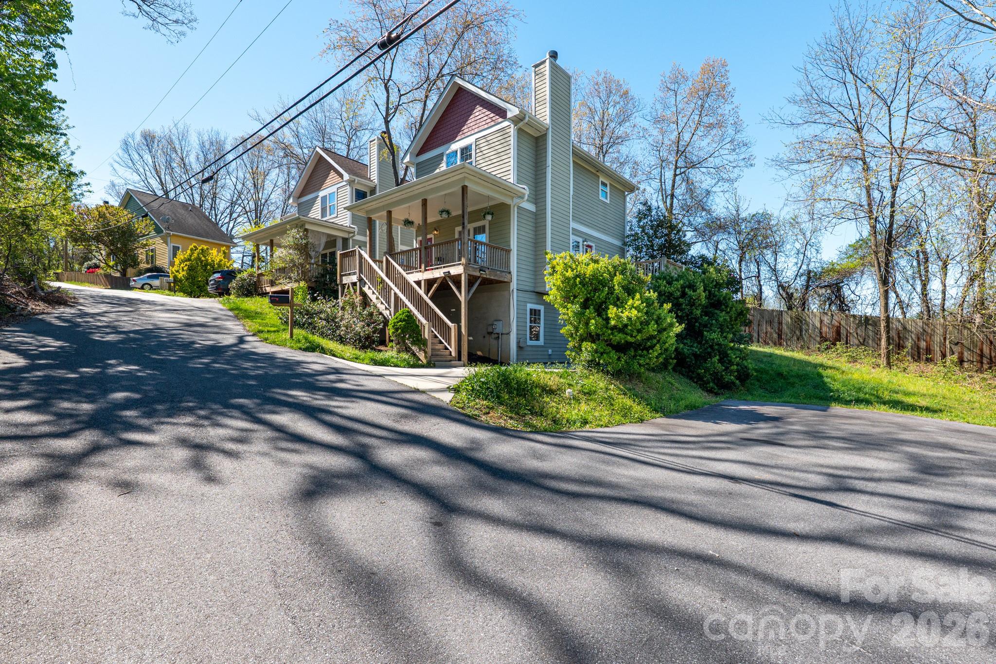 This modern Arts & Crafts home combines the convenience of an in-town Asheville location with a setting that feels unexpectedly private and secluded. Positioned at the end of the road and adjacent to Isaac Dickson Elementary School, the property is surrounded by lush wooded areas and established greenery that create a peaceful natural backdrop. Sidewalks extend all the way to Montford Avenue, and the property sits less than a mile from Asheville’s city center, placing restaurants, shopping, greenways, and everyday essentials within easy reach.

The home offers 3 bedrooms and 2.5 baths in a flexible split-bedroom layout, including a private lower-level suite ideal for guests, a home office, multi-generational living, or potential rental use. The open-concept main level features hardwood floors, high ceilings, and a wood-burning fireplace that anchors the living space. The kitchen blends warmth and functionality with ‘leathered’ solid surface countertops, a sizable pantry, breakfast bar seating, and new appliances. Recent improvements include fresh interior paint and a new roof completed in 2025.

An adjacent parcel is included with the sale, offering additional flexibility and future potential for an ADU, detached garage, or expanded outdoor living space, subject to buyer verification. Opportunities offering this combination of privacy, flexibility, and close proximity to downtown Asheville are increasingly rare. Seller would entertain short-term owner financing with 20% down.