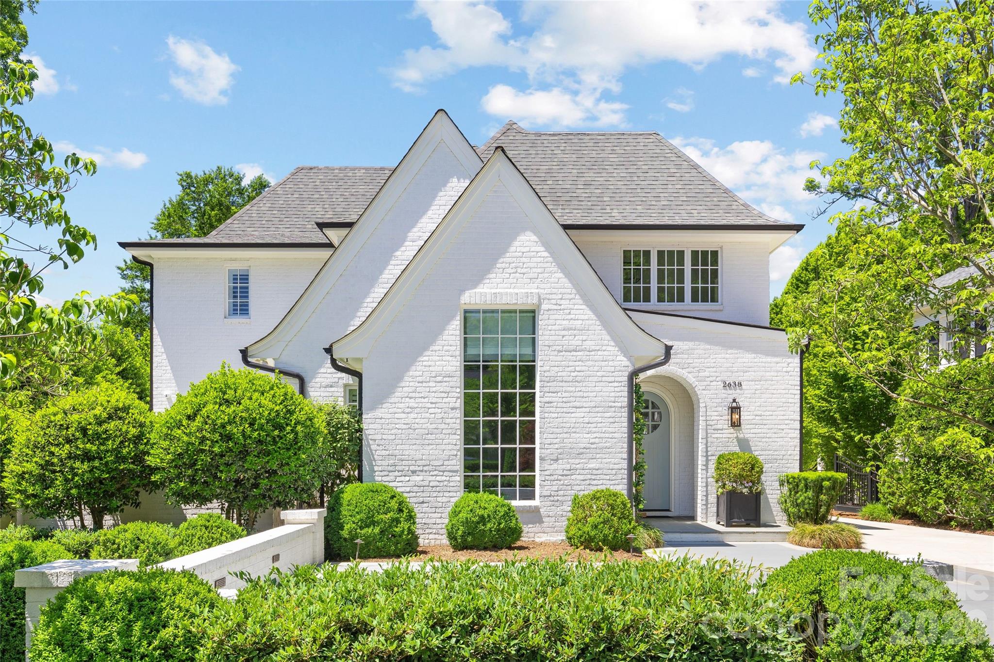 Exceptional move-in ready residence on highly desirable Hampton Ave in the heart of Myers Park! Built in 2017, this pristine brick home offers 5BR and 5.2BA across 4,817 sq/ft of refined living space. Thoughtfully designed for both elegant entertaining and everyday living, the home features beautiful hardwoods throughout, custom millwork and cabinetry, and designer wallpaper and lighting. Beautiful study with soaring vaulted ceiling. The stunning chef’s kitchen boasts white custom cabinetry, quartz countertops, high-end appliances, large center island, walk-in pantry, and breakfast area. Main-level primary suite features an expansive walk-in closet with washer/dryer hookup and spa-like bath with marble flooring, soaking tub, two vanities and frameless glass shower. Upstairs offers four spacious secondary bedrooms with en-suite baths plus a large bonus room with custom built-ins. Finished third-level flex/office space with half bath. Outdoor living includes a covered rear porch with bluestone pavers, fireplace, and in-ceiling speakers overlooking the private fenced yard, plus side courtyard. Electric gated driveway, detached 2-car garage, irrigation, and new tankless water heater (2026). An immaculate Myers Park home inside and out!