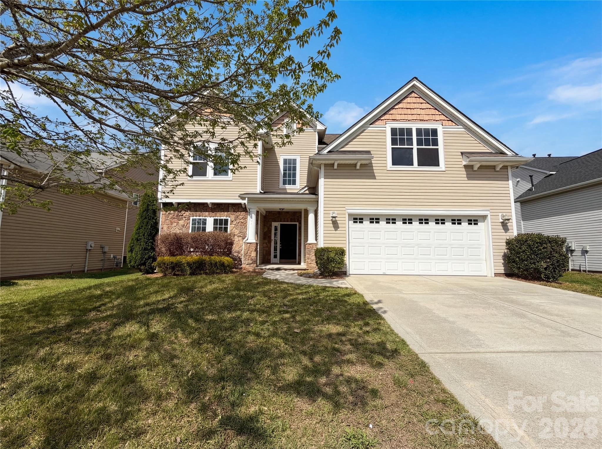 Step into 9696 Ravenscroft Ln NW, arranged for everyday practicality with a layout designed for functionality, featuring a comfortable fireplace. The kitchen is equipped with stainless steel appliances, an accent backsplash, and a central island. The primary bathroom includes double sinks and a separate tub and shower. Outdoor living is extended by a covered patio, a useful storage shed, and a fully fenced backyard. This residence provides a practical and well-appointed living environment. Included 100-Day Home Warranty with buyer activation
