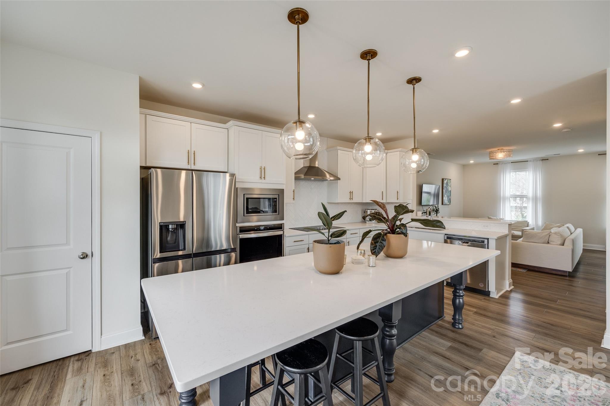 Welcome home to this freshly updated end-unit townhome, offering modern style, an abundance of natural light, and a prime location in West End Charlotte. With 3 stories, 4 bedrooms, and 3.5 bathrooms, this home offers the space and flexibility to live, work, and entertain with ease. Step inside to a welcoming foyer that leads to a spacious first-floor bedroom and full bathroom. This level also features a convenient attached two-car garage. The second level is the centerpiece of the home, offering an airy open-concept design. The kitchen is a showstopper, complete with an oversized island, quartz countertops, stainless steel appliances, and ample cabinetry. Flow seamlessly into the dining area and living room, or step out onto the private balcony. A stylish powder room completes this level. Make your way upstairs, where you’ll find a spacious primary suite featuring a generous walk-in closet and spa-like en-suite. This level continues to impress with two additional bedrooms and a laundry closet. All that’s left to do is move in and make it your own.