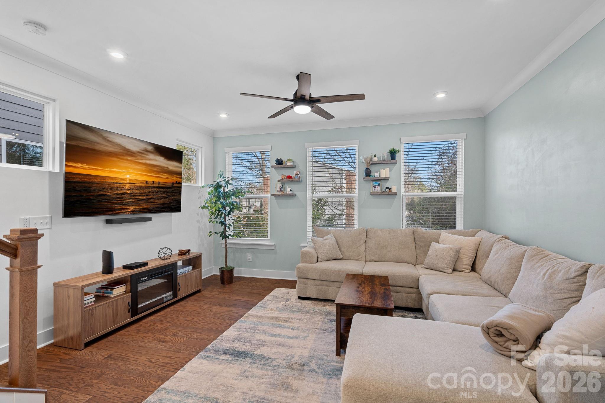 Stylish, like-new townhome in an unbeatable location just steps from the heart of Plaza Midwood! This contemporary 3-bedroom, 3.5-bath residence is filled with natural light thanks to expansive windows and its premium positioning within the community. This home offers the perfect blend of comfort, function, and modern appeal.

The main living level showcases hardwood flooring, recessed lighting, and an open-concept layout ideal for everyday living and entertaining. The designer kitchen features quartz countertops, white cabinetry, stainless steel appliances, subway tile backsplash, and a spacious center island overlooking the living and dining areas. Step outside to the private balcony (approximately 12’ x 4’) to enjoy your morning coffee or evening relaxation.

The lower level provides a private guest bedroom and full bath, ideal for visitors, a home office, or flexible living space. 

Upstairs, the primary suite offers a relaxing retreat with dual walk-in closets and a dual-sink vanity with a glass-enclosed tile shower. A second en-suite bedroom and convenient third-level laundry complete the top floor.

An attached one-car garage and driveway provide additional parking and storage. HOA dues are $240/month and include water, garbage, high speed internet tv and lawn care.  Enjoy walkability to Plaza Midwood, Veterans Park, dining, and shopping, with quick access to Hwy 74 and Uptown Charlotte just minutes away.