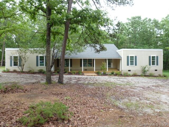 A must see Ranch home sitting on 2 acs in the Buford Area. This is a great home with 3BR, 2BA, dbl garage, lge front porch w/large deck overlooking your private back yard. Home has been completely updated w/new HW floors & carpet. Kitchen  w/all new stainless appliances. Both baths have been updated.  All in an open floor plan w/kitchen, dining, family, & great room with Fpl. Beautiful HW floors, replacement windows, tile baths. Freshly painted new roof and HVAC. To much to list. Move in Ready!