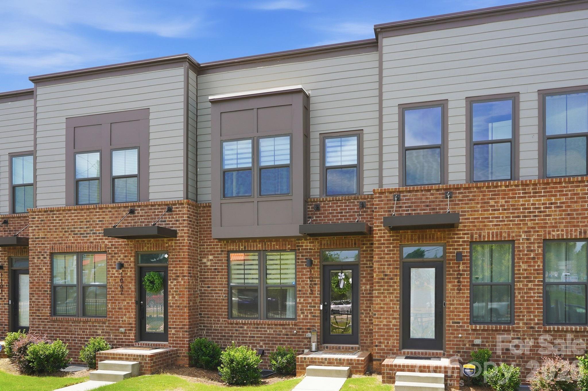 Experience elevated townhome living in the heart of LoSo with this beautifully upgraded residence that stands apart from the rest. Thoughtfully enhanced with custom designer finishes beyond the builder's standard selections, this move-in-ready home offers a sophisticated blend of style, function, and convenience just moments from the Woodlawn Light Rail Station.
The open-concept main level is designed for effortless entertaining and everyday living. Natural light fills the spacious living and dining areas, while the gourmet kitchen serves as the centerpiece of the home with quartz countertops, a large center island with breakfast bar, stainless steel appliances, shaker-style cabinetry, subway tile backsplash, and custom millwork that elevates the island into a true designer feature. Just beyond, the dining area showcases custom built-in cabinetry, providing both beautiful display space and added storage, while the private balcony with motorized shade offers the perfect spot to relax outdoors.
No detail was overlooked, from the upgraded lighting throughout the home to the stylish powder room featuring custom wallpaper and elegant wainscoting.
The lower level offers exceptional versatility with a private guest suite or home office, complete with a full bath, direct access to the attached one-car garage, and a custom kitchenette with beverage refrigerator, creating the ideal space for guests, entertaining, or multigenerational living.
Upstairs, the spacious primary suite provides a peaceful retreat with a large walk-in closet and a beautifully appointed ensuite featuring dual vanities and a tiled walk-in shower. The secondary bedroom has been thoughtfully enhanced with a Murphy bed, allowing the room to function effortlessly as both a guest suite and home office, while maintaining its own private ensuite bath. A conveniently located laundry closet completes the upper level.
Located in one of Charlotte's fastest-growing neighborhoods, you'll enjoy walkable access to LoSo's popular breweries, restaurants, coffee shops, and entertainment, with the Woodlawn Light Rail Station just minutes away for easy access to Uptown Charlotte, Panthers, Hornets, Charlotte FC and Knights games, concerts, Charlotte Douglas International Airport, I-77, and everything the Queen City has to offer.
With designer upgrades that set it apart from neighboring units and an unbeatable location, this exceptional townhome offers a rare opportunity to enjoy stylish, low-maintenance living in the heart of LoSo.