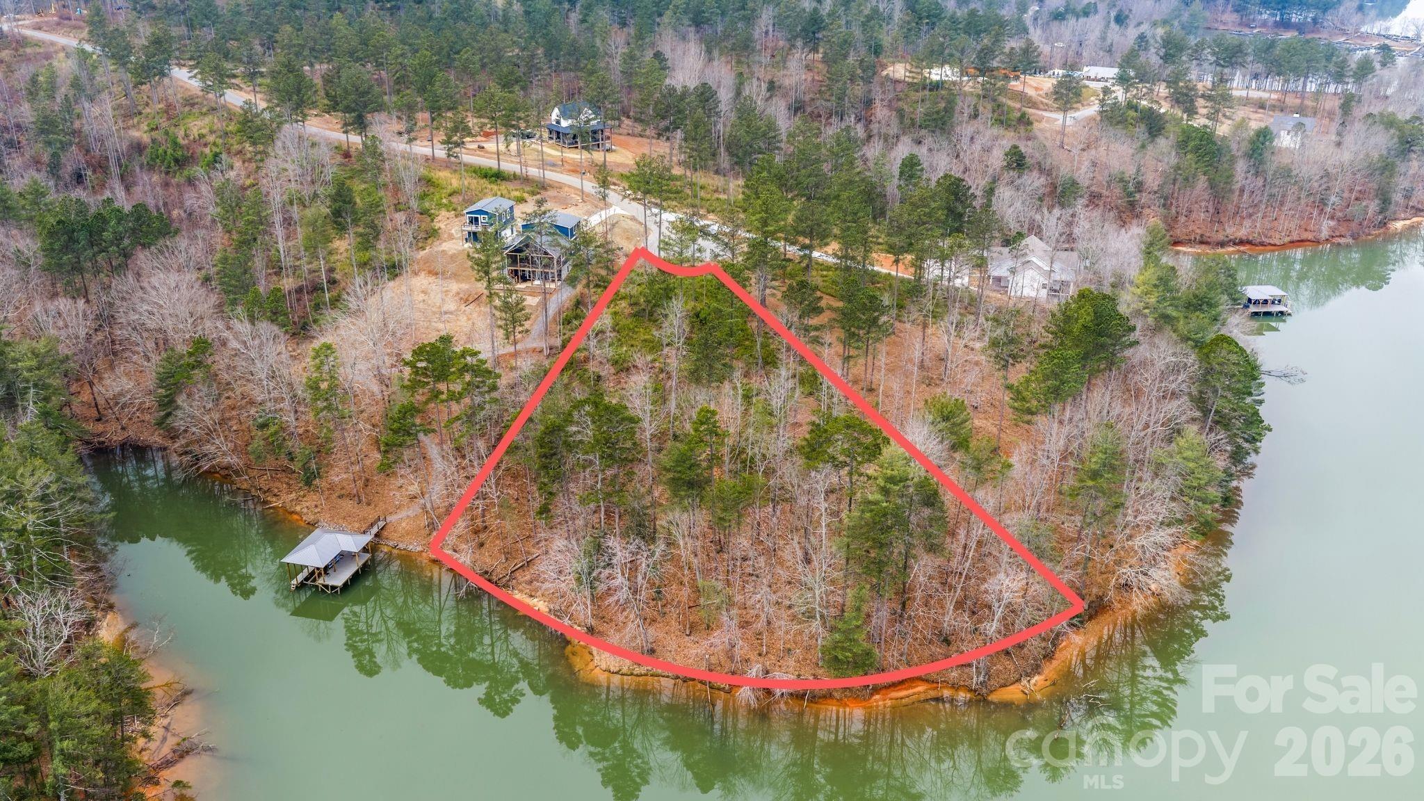 Discover an extraordinary opportunity to build your dream home within the private gates of Lakeside Reserve. This stunning 1.26-acre waterfront homesite offers nearly 300 feet of shoreline, creating an expansive backdrop for lakefront living at its finest.

Nestled along the peaceful waters of Lake Rhodhiss in the foothills of the Blue Ridge Mountains, this property delivers the perfect balance of natural beauty and everyday convenience. While surrounded by serene landscapes and sweeping water views, you remain within easy reach of Hickory, Charlotte, Asheville, Winston-Salem, and Blowing Rock.

Lakeside Reserve was thoughtfully designed to offer both refined comfort and an active outdoor lifestyle. Residents enjoy privately maintained paved roads, underground utilities, a resort-style community pool, lakeside pavilion, pickleball courts, sandy beach area, scenic walking trails, kayak launch, fenced boat storage, and inviting gathering spaces complete with an outdoor fireplace.

Whether you envision a peaceful retreat or an elegant lakefront estate, this rare waterfront parcel provides the space, privacy, and community amenities to bring your vision to life.