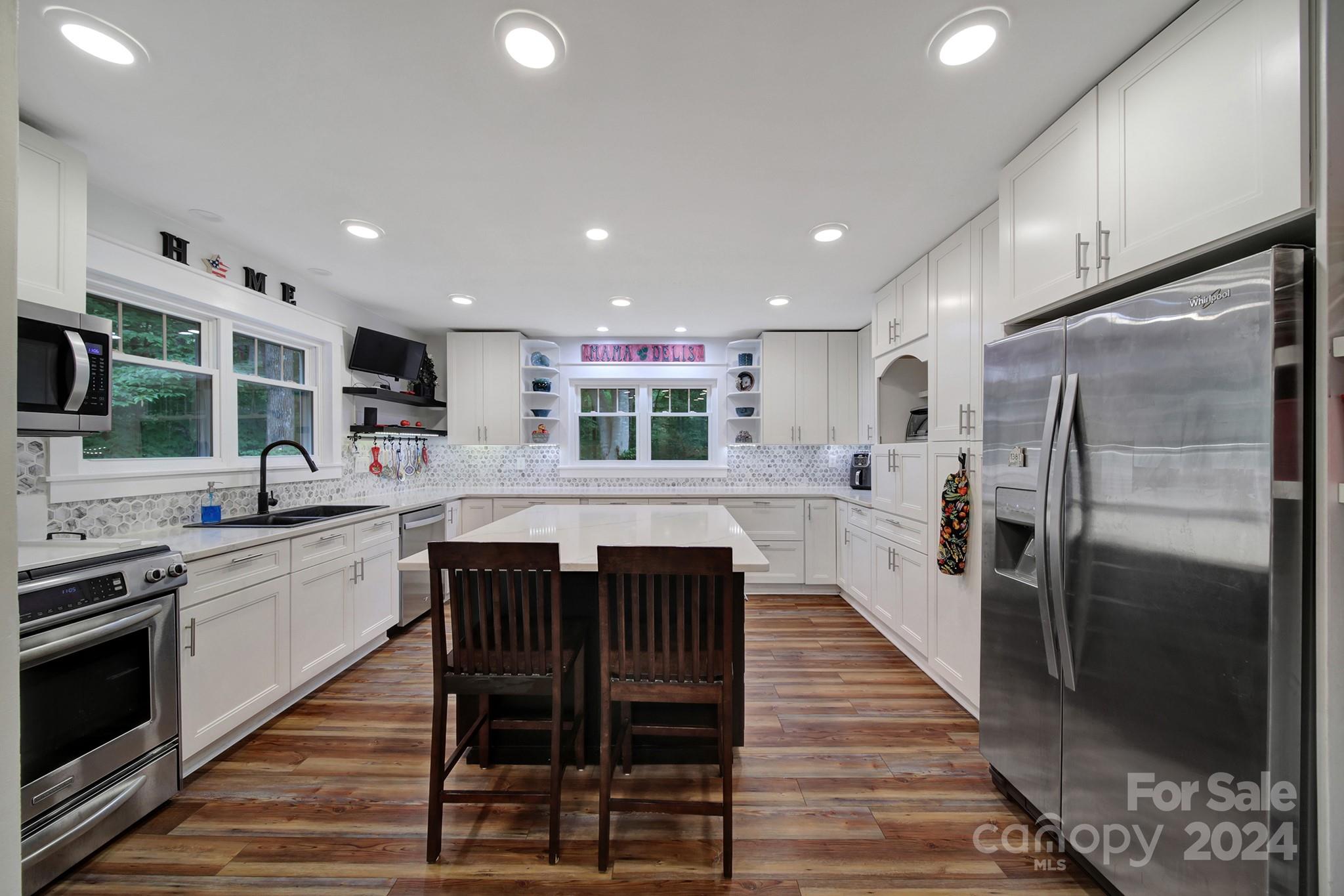 New Price Adjustment! Completely renovated one of a kind craftsman style home on 2.5 acres. Step into the grand entryway of this beautiful open concept home. Impressive vaulted ceiling sunrm w/tons of natural light. Home boasts built-ins that won't disappoint. New flooring throughout. Chef's kitchen features custom soft close cabinetry, pull out storage, quartz counters, large island, built-in pantry, ss/appliances, gas cooktop & opens to the gigantic dining rm w/built-in serving station. Spacious vaulted ceiling great rm. Primary suite on the main w/custom walk-in closet. Upper level will blow you away! Many endless possibilities with the unique additional bedrms & flex spaces. Enjoy relaxing in the hot tub on the double level deck which overlooks the private wooded sanctuary. Fenced area for pets. 2 sheds w/new roofs. Cozy trex decking front porch. Freshly stained cedar siding. New water softener. Rinnai tankless hot water heater. Leafguard Gutter System. NO HOA!