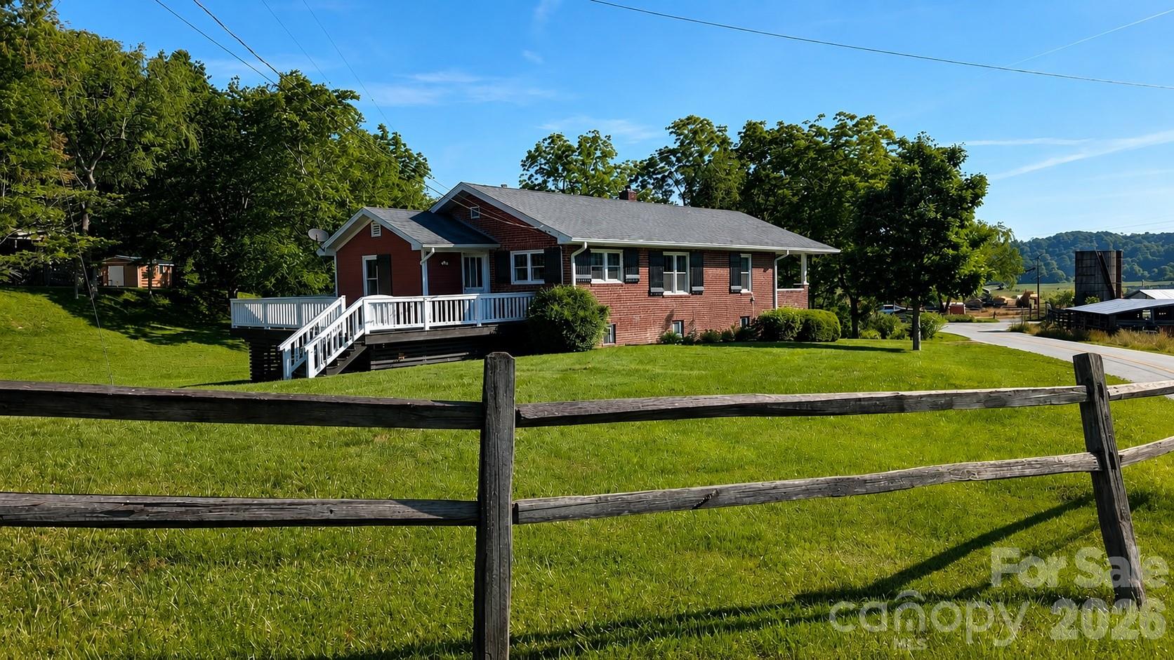 Now available and ready for its next owner! This impeccably updated farmhouse combines timeless character, quality craftsmanship, and thoughtful modern updates in a peaceful country setting with beautiful mountain views—all less than 10 minutes from vibrant downtown Brevard. From the new hickory flooring and Pella windows to the updated kitchen, baths, plumbing, electrical, and fresh interior finishes, this home has been carefully renovated and is truly move-in ready.

The flexible floor plan offers broad appeal, highlighted by a spacious primary suite featuring an ensuite bath with a large walk-in shower and dual vanity. The result is a home that truly sparkles, with an inviting atmosphere and beautiful mountain and pastoral views from the living, dining, and kitchen areas.

There's also exceptional bonus space with a full, unfinished basement and one-car garage. Ideal for a workshop, hobby area, fitness space, or abundant storage, the basement also offers convenient interior access to the home (ceiling height is slightly below 7 feet).

Outside, a spacious open deck and private covered porch provide the perfect setting to take in the sounds of the adjacent creek while overlooking the beautiful mountain views of the French Broad River Valley. A level backyard offers plenty of room for entertaining, gardening, or outdoor activities, while the large two-level barn presents exciting possibilities for additional storage or future renovation.

The quiet location features minimal traffic, with paved roads providing easy year-round access. Popular with cyclists, kayakers, and outdoor enthusiasts, this area offers the peace and privacy of country living without sacrificing convenience. Here, you truly can enjoy the best of both worlds—serene mountain living just minutes from everything Brevard has to offer.

You simply won't find a nicer renovation with these views in this price range. One-year home warranty included.