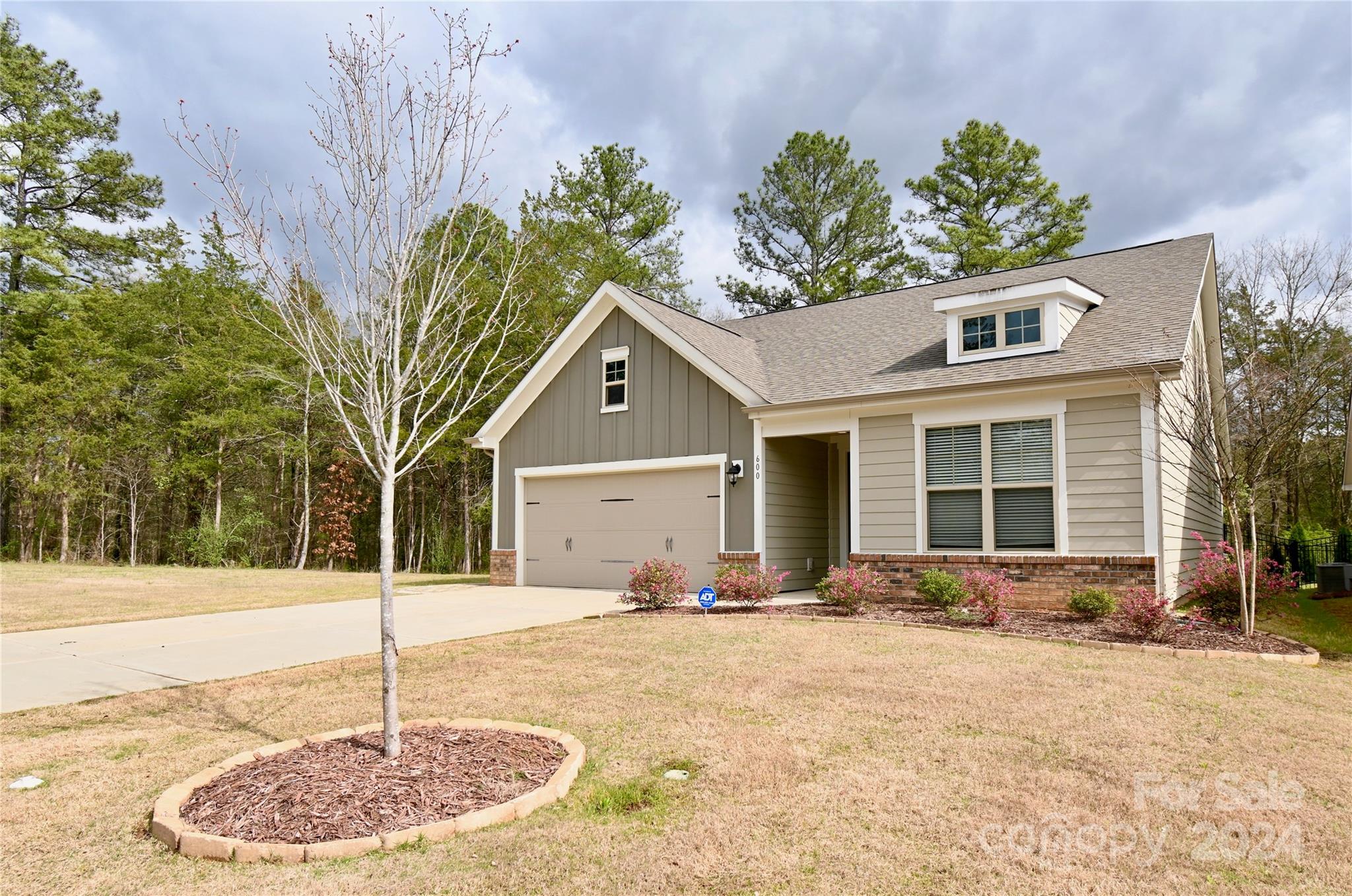 This 2/2 bath ranch home in Rhyne Estates is on a desirable level, cul-de-sac lot, adjacent to a huge common area and lake. Upon entering this wonderfully maintained home displays open floorplans, laminate wood flooring and crown molding that flows throughout. The kitchen shows granite counter-tops, SS appliances, gas range w double ovens, island with breakfast bar and 42" custom cabinetry with soft close drawers. Recessed ceiling over the primary bedroom with bathroom includes large vanity with dual sinks, tiled shower and walk in closet. The generous office has custom built-in bookshelves and views the trees. Upstairs awaits an enormous loft that can be an additional bedroom, media room or den. Walk-in-attic has window and could be finished for extra living space/bedroom. Out back lies the patio w/pergola with privacy and fencing.