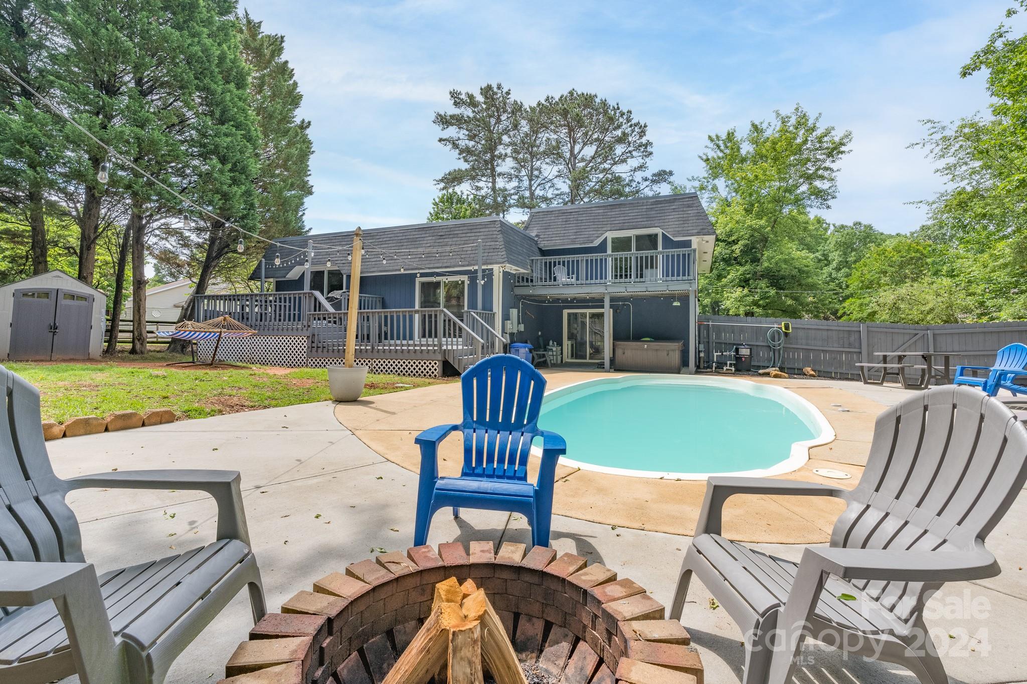 Live your best lake & pool life this summer in this relaxing retreat nestled in the heart of historic Tega Cay! This spacious, updated, well-maintained home offers ample room to entertain & for everyone to enjoy their own space when it's time to relax. The open concept main living area features chef's kitchen, dining room & living room w/multiple decks leading to the private fenced-in backyard oasis.

Enjoy the convenience of 2 primary bedrooms w/ensuite bathrooms. Upstairs primary offers a private deck overlooking the pool. Downstairs primary was remodeled in 2020 & offers a HUGE walk-in closet & renovated bathroom w/dual showerheads. All 3 bathrooms have been recently updated.

The lower level flex space leads to a covered patio w/hot tub (2021), pool & storage building.

Major updates include: New roof (2022), new Bosch dishwasher (2023), new low energy pool pump & filter (2023), new tankless water heater (2021), new carpet & LVP flooring (2023) & vapor barrier in crawlspace.