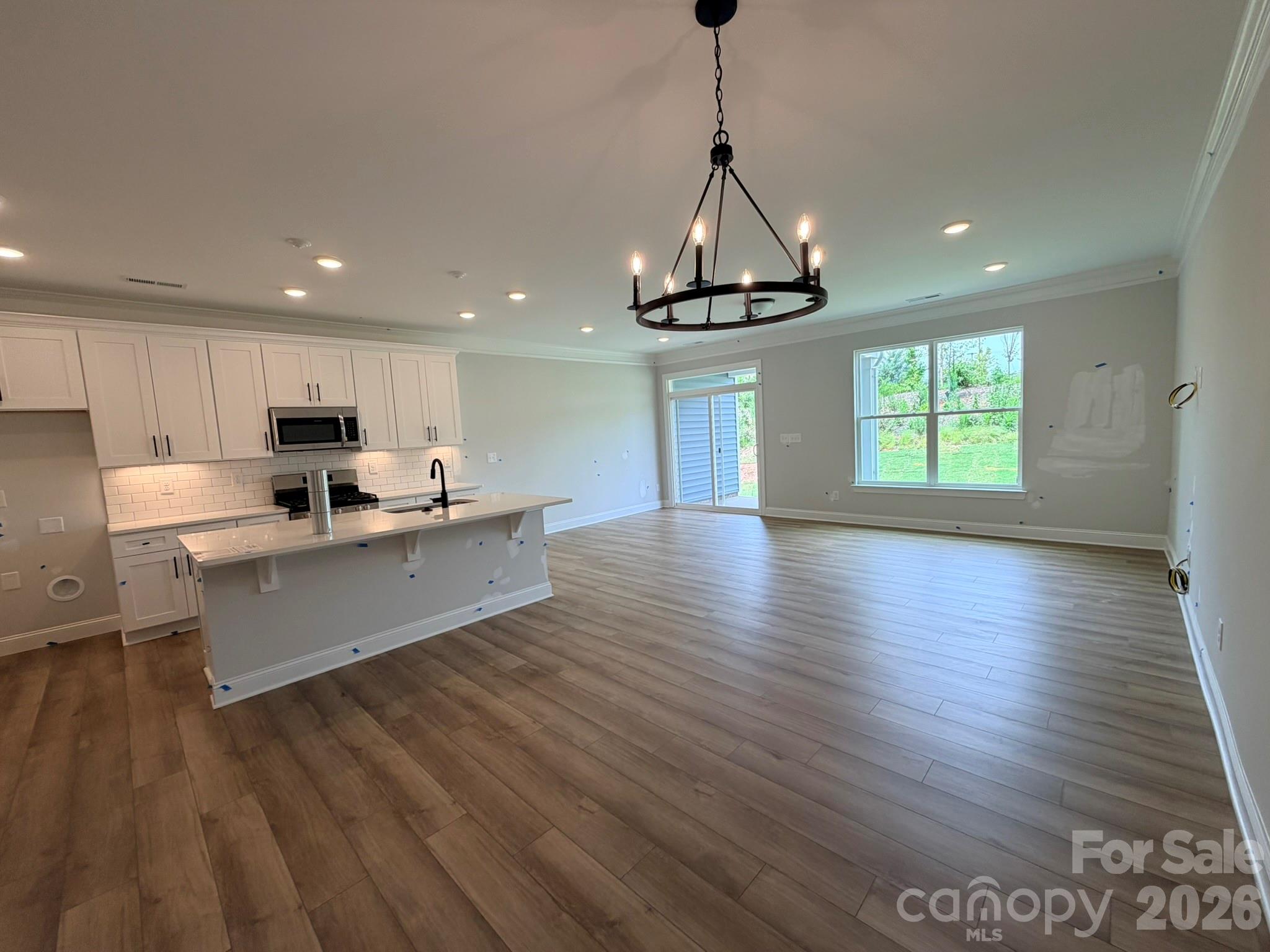 Welcome to a brand-new master-planned community in Troutman! This Ashland plan has 3 bedrooms, 2.5 baths, and more than 1,800 square feet of living space. Enter the home through the foyer with tray ceiling and a convenient, beadboard drop zone to see the open kitchen, dining area and family room that walks out to a covered porch. The kitchen features white, Shaker-style cabinets and quartz counters, a spacious island, tile backsplash, and stainless appliances, including a gas range and microwave. The open main floor has beautiful and durable Enhanced Vinyl Plank (EVP) flooring throughout. The upper floor features a loft, bedrooms, full baths and laundry room. The primary bath has a tiled shower, dual-sink vanity, and linen closet. The upstairs full bath has a tub/shower combo. All baths have white cabinetry and white quartz counters. Enjoy easy access to interstates, shopping, dining & recreation. Community amenities include an outdoor pool and cabana. Find out more today!