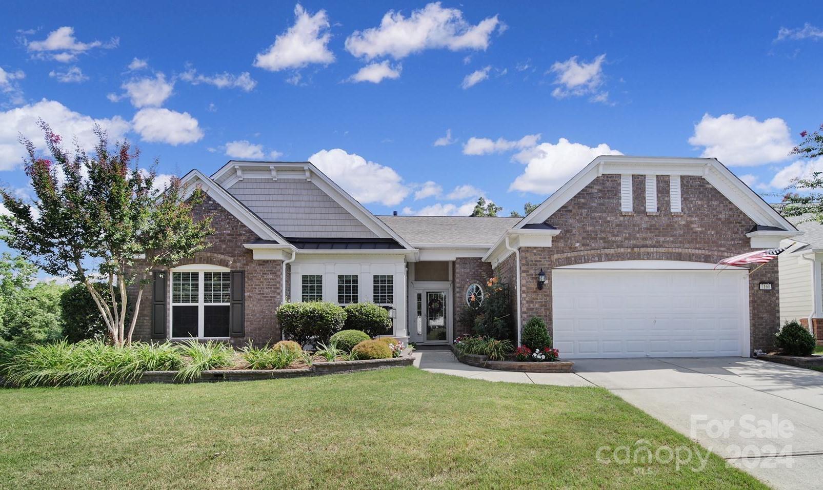 Gorgeous Crestwood Meadow home in amenity-rich Sun City! You'll love the Brazilian teak floors in the dining room & great room (w gas-log fireplace), as well as the crown molding & wainscoting accents! Enjoy cooking in the spacious kitchen w/ SS appliances, a gas cooktop, a large island w/ bookcase shelving, granite counters, tile backsplash, a built-in desk area, pantry w/ wood shelving, & a breakfast nook! The primary suite has windows overlooking the trees, and an en-suite bathroom w/ a soaking tub, frameless glass shower, & a large walk-in closet! 2 guest bedrooms, a hall bath, & an office w/ French doors sit in the front of the home. Relax in the 4-season room that overlooks the private view of the trees, or entertain on the beautifully landscaped paver patio w/ seasonal views of the lake! You also can't beat this home's central location to one of the community walking trails, right outside the back door! Extended 2-car garage w/ VersaLift storage system! Come see this home today!