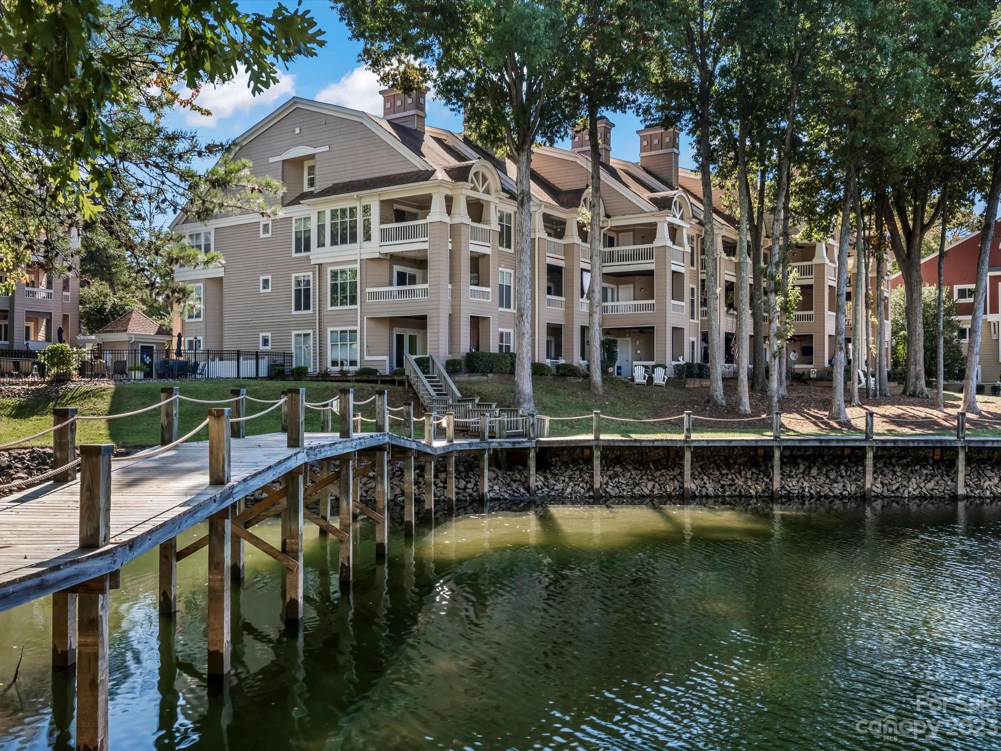 Glorious sunsets from your penthouse balcony overlooking Lake Norman where you will enjoy unforgettable evenings of entertainment & laughter. Step outside to a world of recreation with an outdoor saltwater pool, private pickleball community, boardwalk trails, & endless adventures on the water, including a SUP/Kayak launch. Included is a highly-sought after transferable, leased boat slip. Stroll to nearby dining & live music & Historical Davidson for its nationally acclaimed dining, boutiques, & social events! You are minutes to Charlotte & its thriving arts scene, gourmet cuisine & pro sports. Greeted by ambiance, elegance, & serenity, this rare, 2-level waterfront penthouse offers comfort & beauty of lakeside living. Hardwood flooring & contemporary paint are backdrops to a kitchen that steals the spotlight! The LR vaulted ceiling adds a layer of grandness coupled with a wood-burning fireplace. Desirable upper level loft. Furnishings negotiable. Refrigerator, washer, & dryer, remain.