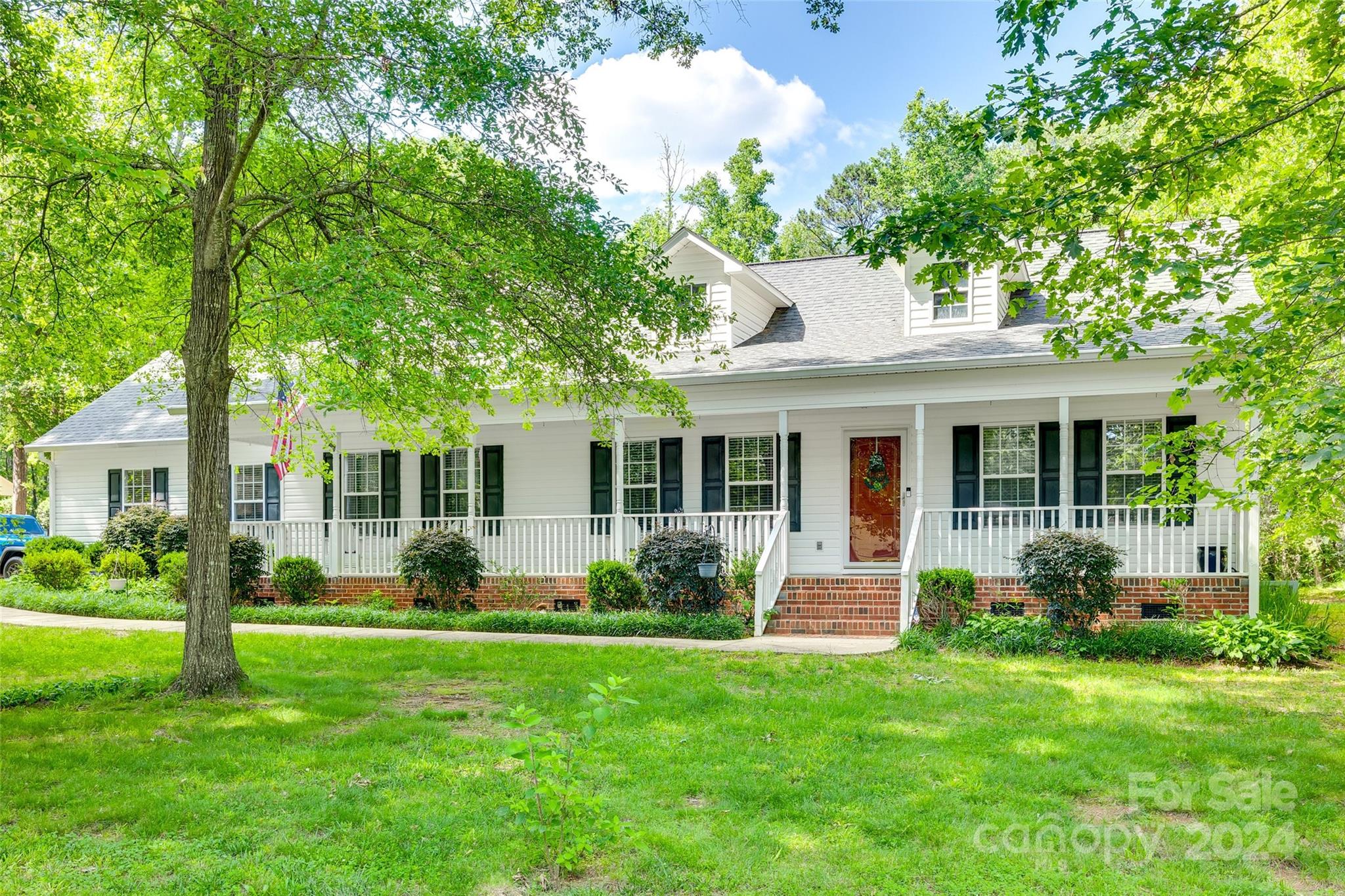 Nestled on a serene 1.56-acre corner lot, this charming three-bedroom, two-bath ranch home exudes warmth and comfort. The inviting rocking chair front porch sets a welcoming tone, perfect for leisurely mornings with a cup of coffee. Inside, the cozy living room features a gas fireplace and vaulted ceilings. The spacious kitchen boasts a breakfast bar and a generous dining area, which opens onto a back deck that overlooks the expansive backyard, ideal for outdoor gatherings and enjoying the tranquil surroundings. Updated kitchen and bathrooms and freshly painted throughout. Additionally, the property includes a detached garage/workshop(590 sq ft) which has AC/heating unit and epoxy coated floors and offers ample space for projects and storage. With no HOA to worry about, this home provides both freedom and charm in a picturesque setting.