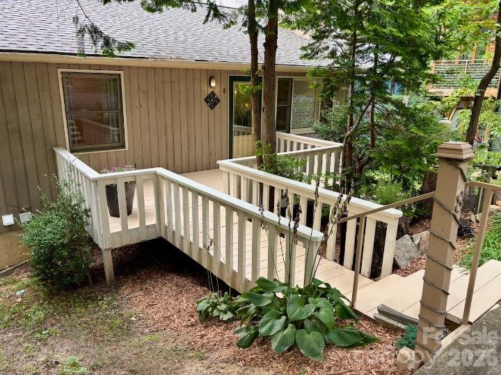 (Seller financing is available. Contact listing agent for details.) Nestled into an ideal and coveted West Asheville neighborhood overlooking the River Arts District, and just a few walkable blocks from shops, restaurants and entertainment, are two rare and artistic condo units being sold as one, with only one very affordable association fee.  Truly a two for one scenario allowing for a multitude of uses.  Perfect for multigenerational, Live in one and rent the other or live upstairs and have your dream studio downstairs!  This is literally every musician’s and artist’s dream, but it could also be the perfect scenario for a home office separated from the main living space.  Perfect balance!  Both spaces are lovingly assembled with unique woodwork and tile decor, stainless steel appliances and efficient floor plans.  The upstairs 2 bedroom 1.5 bath unit features beautiful water and sky decor, vaulted ceilings, an earthy stone fireplace, a spacious and open kitchen and great room with silestone countertops, high end cabinetry and appliances and a balcony overlooking the backyard.  The downstairs 1 bed 1 bath unit features an efficiency plan with a combined space for the kitchen, living and dining areas, and contrasts the upstairs with an earthy tone.  Love, love, love is what you see in the custom maple countertops and cabinets and unique light fixtures.  Both units have been meticulously maintained and await your vision and appreciation! ~~ In the seller's own words ~~ "Riverview Drive is aloft the grand ole French Broad River, taking flight above the Wedge and the biking trails of the Fat Tire producers of hearty ales flowing into this ideal and desired West Asheville neighborhood.  With the River Arts District buzzing down below there is space to explore Archetypes of the finest WAVL has to offer in culinary delights - a Hole in one with donuts and Taco Billy’s Mama’s favorite or a Hop on over to the Owl for croissants with a skip and a trail walk.  Culinary explorations lead the way to walkable blocks to shops, restaurants and entertainment.  Creative endeavors to move in with a built in community of kindness. Sanctuary.  Unique.  Custom. Hand made maple countertops below and Silestone counters above.  All of the forest represented in the floors.  A mosaic of maple, tile, glass, stainless steel appliances and flowing efficient floor plans sings the praises of the creator within.  One of two upstairs bedrooms has a west facing balcony and the east bedroom comes with 1.5 bath.  Features beautiful water and sky decor, vaulted ceilings with wood accents and floors, an earthy stone fireplace, a spacious and open great room and kitchen with high end maple cabinetry and appliances and a balcony overlooking the backyard.  The downstairs 1 bed 1 bath unit features an open floor plan with a combined space for the kitchen, living and dining/office areas, and contrasts the upstairs with an earthy tone, like soft green moss under our toes.  Come see the Cosmic whale mural under the treetops above the FBR.  Meticulously maintained number eight makes it great with new HVAC efficient system installed this spring. " (Request Brochure to read the remainder of seller's poetic telling of this home).  Schedule your showing today and claim this heartfelt home as your own!