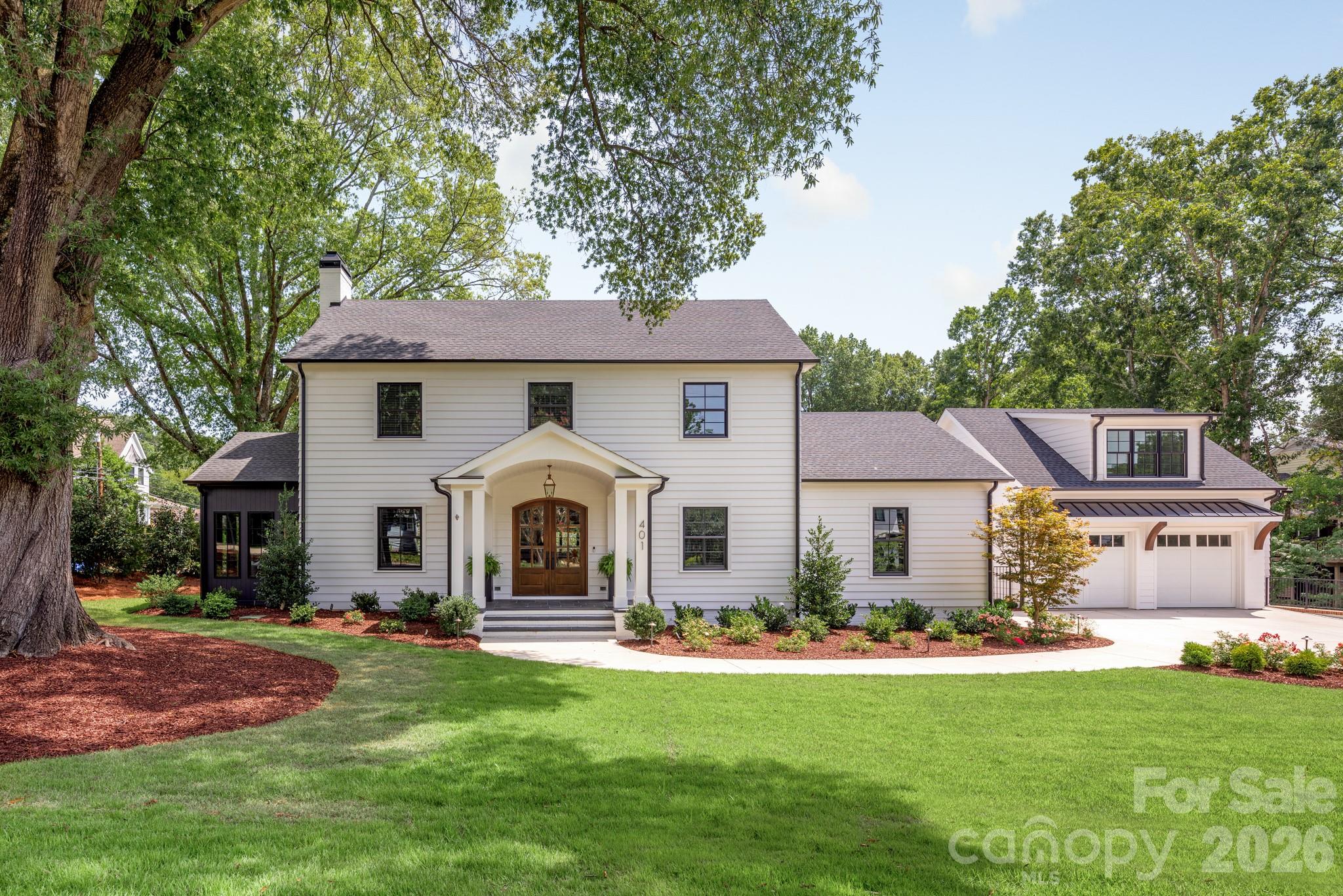 Impeccably reimagined by Eric John Builders, this historic colonial masterpiece in the heart of Downtown Davidson harmonizes timeless architecture with modern luxury. Spanning 9,217 sqft., including a carriage house, the home features French white oak floors, select deep-hued accent walls that create sculptural moments, and thoughtfully curated living spaces illuminated by luxury lighting.

The chef’s kitchen showcases waterfall countertops, a custom hood vent, herringbone backsplash, and a scullery, while an atelier wet bar with wine refrigerator and mirrored backsplash elevates entertaining. Multiple fireplaces anchor interior spaces, complemented by a screened patio with fireplace and a built-in outdoor grilling station.

The spa-inspired primary suite features dual vanities, a soaking tub, and a frameless glass shower with feature tile walls. A breezeway connects the main residence to the carriage house, which provides private living quarters with kitchen, bath, bedroom, and living room. Expansive outdoor areas include a saltwater pool, spa, and meticulously landscaped gardens—perfectly situated to enjoy all that Downtown Davidson has to offer.