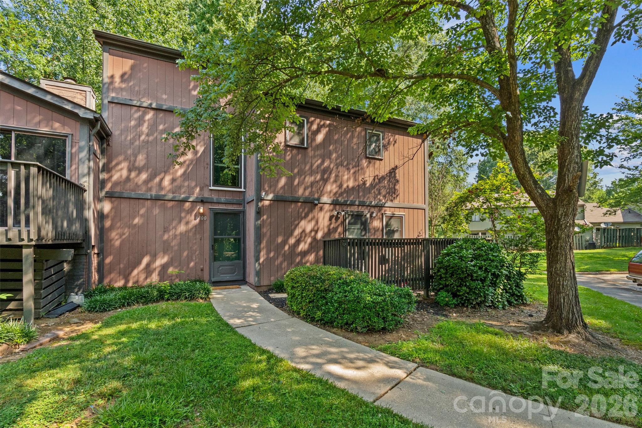 Welcome to 6100 Honeysuckle Lane, a charming 3-bedroom, 2.5-bath townhome offering comfort, convenience, and access to great community amenities. The spacious living area features a stone fireplace and opens to a functional kitchen with ample cabinet space and room for everyday living. Upstairs, you’ll find all three bedrooms, including a generously sized primary suite. New insulated windows were installed in 2024 for added efficiency and comfort. Enjoy the private back patio with space for grilling and direct access to the greenway. Community amenities include an outdoor pool, clubhouse, tennis courts, and playground. Conveniently located near shopping, dining, and everyday essentials.