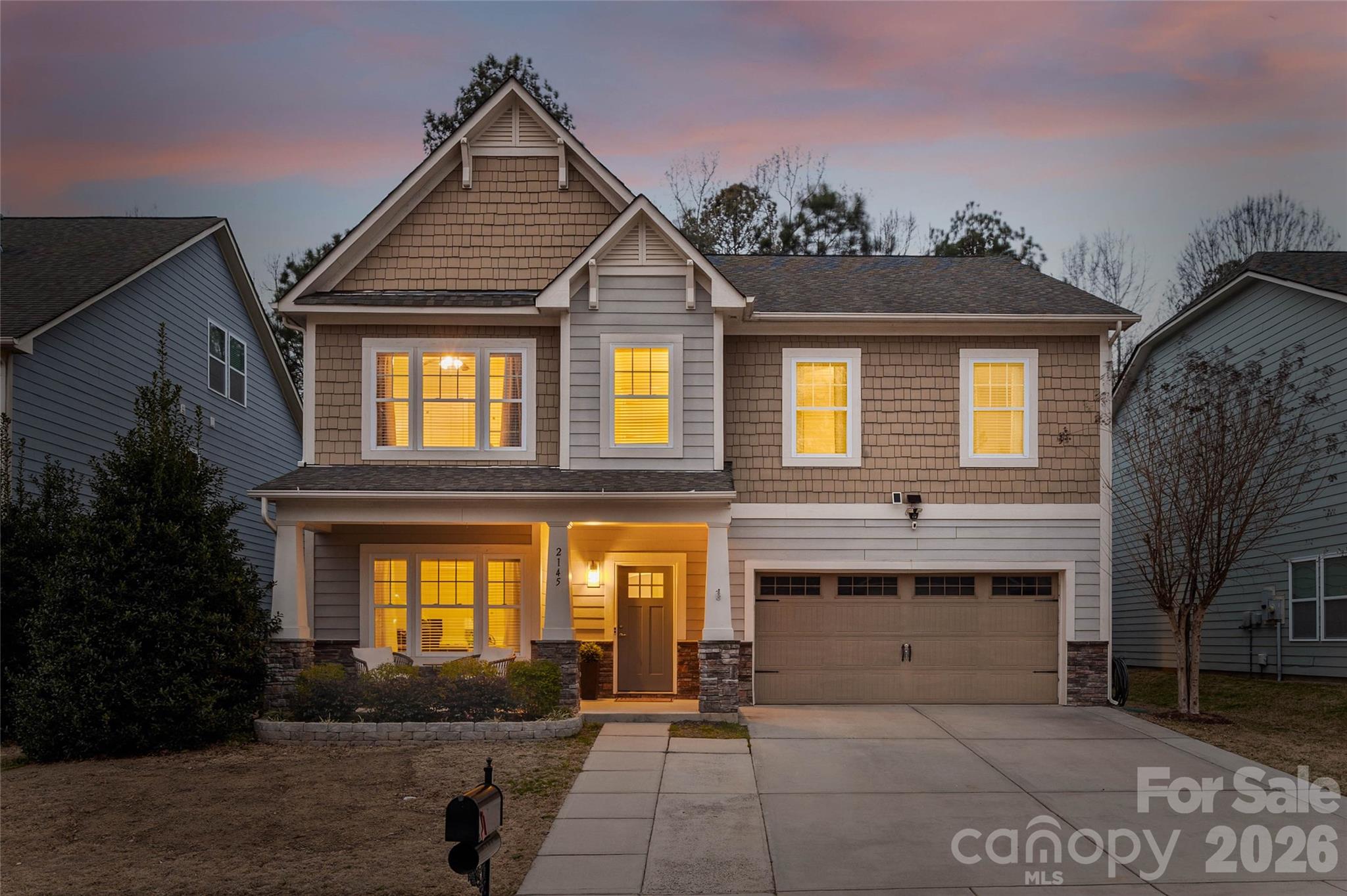 Nestled in a wooded backdrop, this well-maintained Tega Cay home is ready to be yours! A covered front porch greets you as you make your way into the open & light-filled floor plan, with gleaming wood floors that run throughout the main level. The updated kitchen boasts stunning counters, a large undermount sink, stainless steel appliances, tile backsplash, designer pendants, butlers pantry, and generous walk-in pantry. The great room is the perfect place to enjoy views out to the backyard, where you'll find a level and fenced yard, patio with pergola, and a charming stone patio with firepit and sitting wall. Rounding out the downstairs is a built-in drop zone, half bathroom, office with solid doors for sound barrier, and dining room with tray ceiling. As you head upstairs on the redone wood stairs, you'll find new carpet all upstairs (2025) that leads you to a generous primary suite. Double doors welcome you in, and you'll fall in love with the dual closets, walk-in tile shower, garden tub, 2 sinks, and water closet. The laundry room is directly next to the primary, and was completely redone with tile flooring, sink, modern counters, and ample cabinet storage. 2 bedrooms share an attached bathroom, and another bedroom and full bath, as well as bonus with LVP flooring, complete the upstairs. Lake Ridge is an amenity rich community, with a  jaw-dropping pool with water slide, separate shallow pool, and sun shade areas to lounge, as well as tennis and pickleball courts, basketball courts, covered playground, walking trails, sidewalks, and more! With top rated Fort Mill schools & a convenient location - Welcome Home!