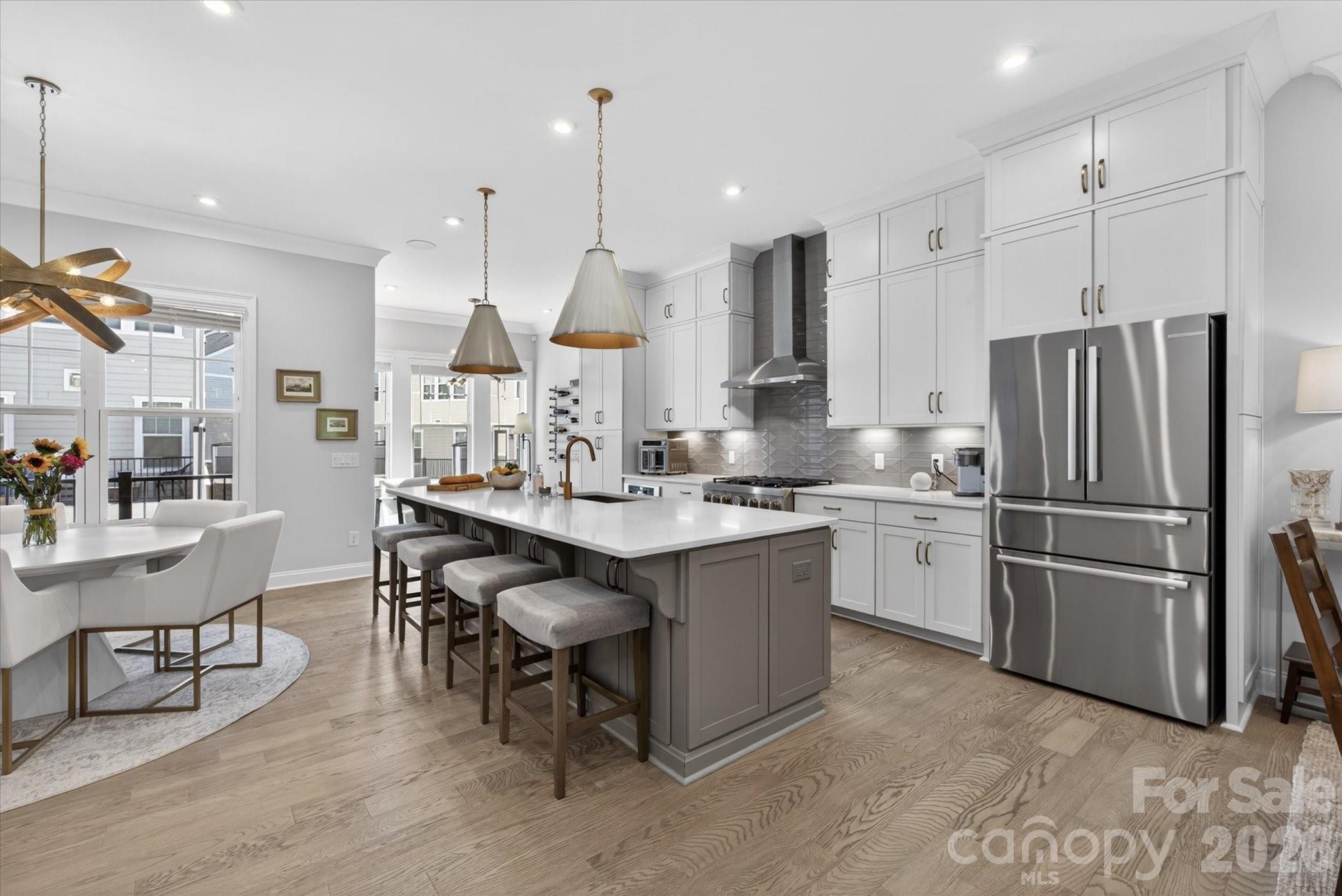 Luxury living defined by natural light, immaculate and  elegant design, this exceptional townhome offers a seamless blend of sophistication and comfort in one of Elizabeth Glen’s most coveted settings. Surrounded by mature trees and charming, sidewalk-lined streets, the home feels effortlessly integrated into the established Elizabeth neighborhood evoking the presence of a single-family residence while offering the ease of low-maintenance living.
The moment you step inside, the home unfolds into a bright, thoughtfully designed floorplan, highlighted by a stunning chef’s kitchen with an oversized quartz island, a private second-floor balcony, and a luxurious primary retreat featuring a spa-inspired bath. Listen to your favorite artist throughout the home on the Sonos sound system.  Spacious, thoughtfully designed storage solutions are seamlessly incorporated, offering both functionality and a clean, uncluttered aesthetic. The outdoor living experience is equally compelling. A spectacular sky terrace captures breathtaking sunset views and  a rare sense of privacy with tranquil vistas of mature hardwoods providing a peaceful, tree-lined backdrop that is increasingly rare in city living. Additional covered balcony overlooking a private driveway court.  Every detail has been carefully curated, with elevated lighting and custom finishes throughout, resulting in a home that feels refined and distinctly bespoke. The custom, lighted bar area serves as a true focal point featuring under-counter lighting, striking floor-to-ceiling custom glass door entrance, display cabinetry, and exquisite millwork that blends artistry with function. This Smart home is also exceptional savings on utilities.  For the car enthusiast, the garage is a standout feature, thoughtfully designed with custom storage and epoxy flooring, creating a polished and highly functional space. Abundant parking for both owners and guests including a two-car garage, oversized driveway, and convenient access points along with unlimited street parking which further enhances the home’s everyday livability. Incredible location close to Uptown, Southend, Dilworth, Plaza-Midwood and southend.  Close proximity to 2 of the regions premier Healthcare Systems.   
Simply put, this luxury townhome presents a rare opportunity to own one of Elizabeth Glen’s most desirable residences.