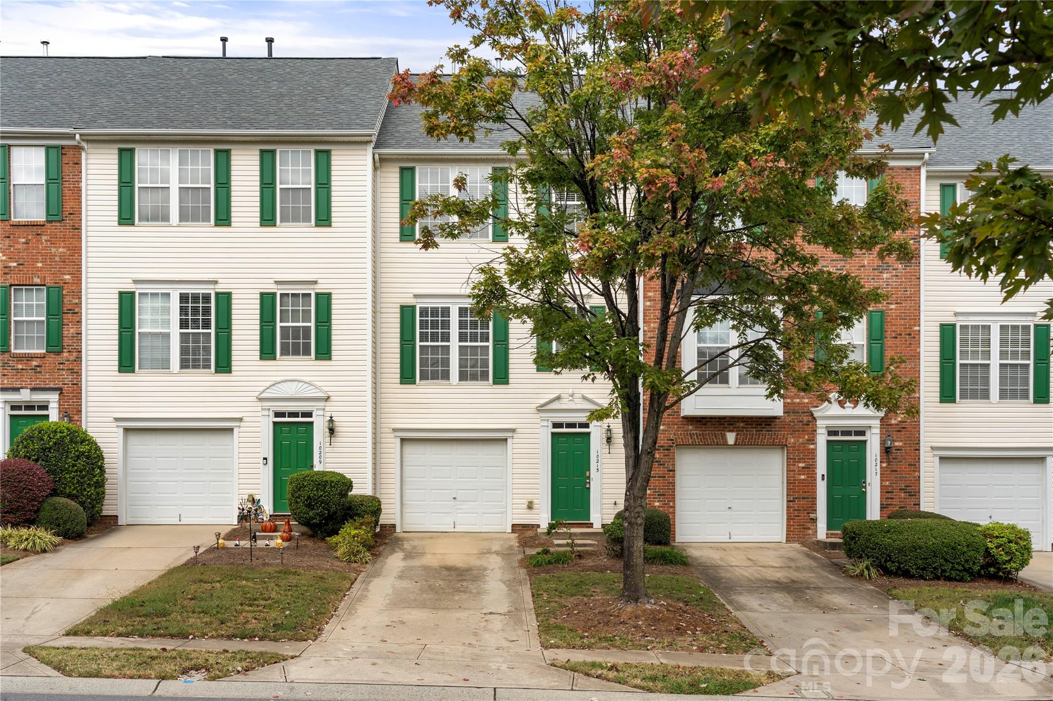 OWN FOR LESS THAN RENT! Qualified buyers can secure 100% financing or special grant money for this sprawling, 1,927 sq ft University City townhome. Featuring a rare 3-story layout, the main level boasts real wood floors and a bright kitchen overlooking lush green common space. Upstairs features two massive dual-primary style bedrooms with walk-in closets. The massive, lower-level 497 sq ft bonus room offers private entry—perfect for a 3rd bedroom, home business, roommates, or media room. PEACE OF MIND: New HVAC (2024), and the seller is paying off the roof special assessment in full at closing!  Minutes to UNCC, I-85, and I-485