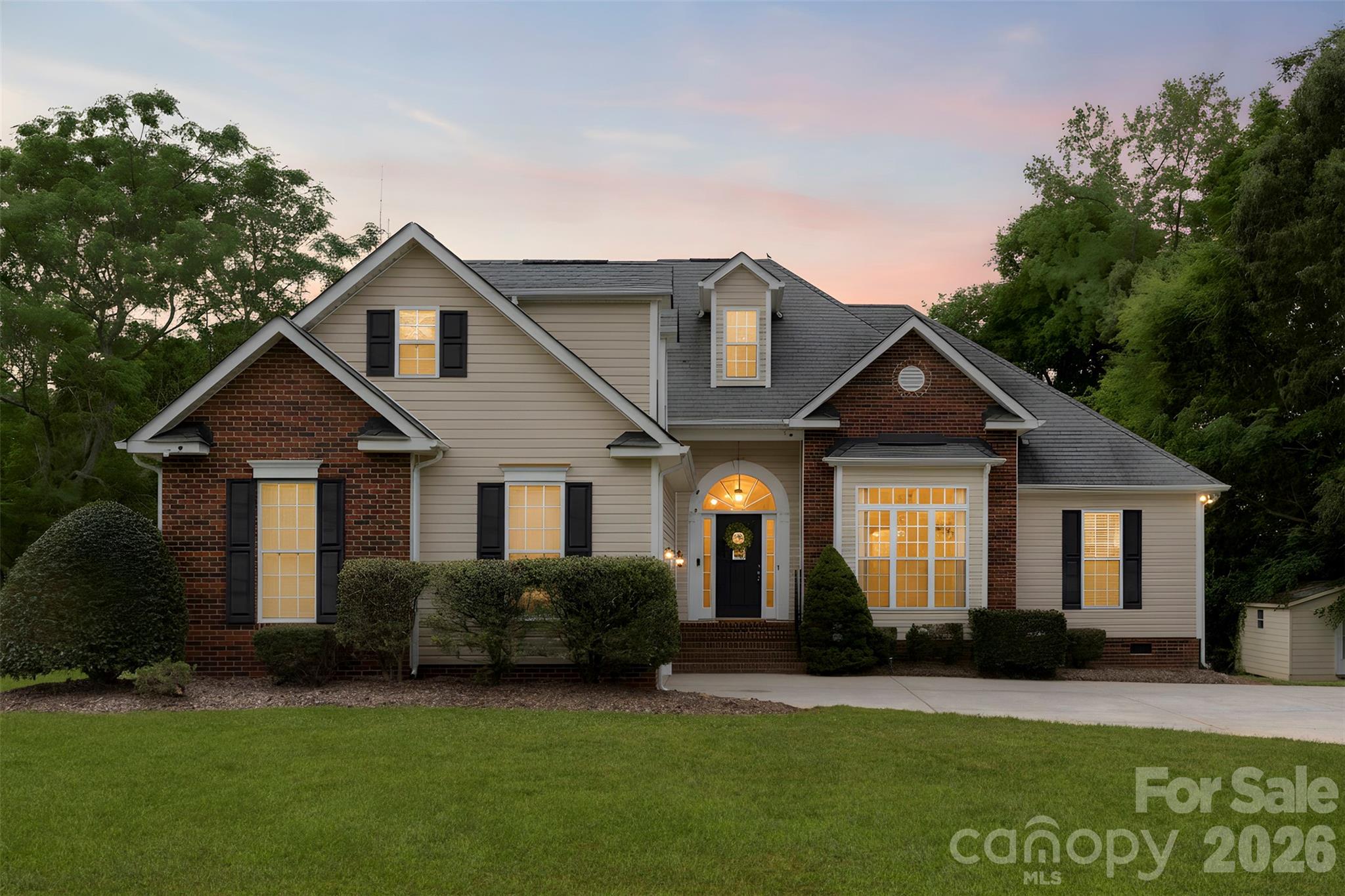 Welcome to the kind of home where mornings begin with coffee on the screened porch, evenings are spent watching the sunset over the backyard, and there's plenty of room to gather, relax, and create memories for years to come. Set on a spacious lot with mature landscaping and peaceful surroundings, this beautifully maintained brick home offers the perfect balance of comfort, privacy, and functionality. From the moment you arrive, you'll appreciate the inviting curb appeal and the sense of space that is becoming increasingly difficult to find. Inside, the home is filled with natural light and thoughtfully designed living spaces that make everyday life effortless. The open flow between the main living areas creates an ideal setting for entertaining guests, hosting holidays, or simply enjoying a quiet evening at home. Large windows frame views of the property, bringing the beauty of the outdoors inside. The primary suite serves as a true retreat, offering generous space to unwind along with the rare luxury of dual walk-in closets, providing abundant storage and organization. Additional bedrooms offer flexibility for family, guests, hobbies, or a dedicated home office. One of the standout features of this home is the screened porch, where you can enjoy Carolina evenings without the nuisance of bugs. Whether you're hosting friends for dinner, curling up with a good book, or savoring your morning coffee while listening to the sounds of nature, this space is sure to become a favorite. Beyond the home itself, the expansive yard provides endless opportunities for gardening, play, outdoor entertaining, or simply enjoying the privacy and tranquility of your own piece of property. A detached workshop/outbuilding offers additional versatility, making it ideal for hobbyists, storage, woodworking, equipment, or creative projects. Offering the space, flexibility, and lifestyle today's buyers are searching for, this Sweetgrass Lane property is more than just a home—it's a place where life slows down just enough to be enjoyed.