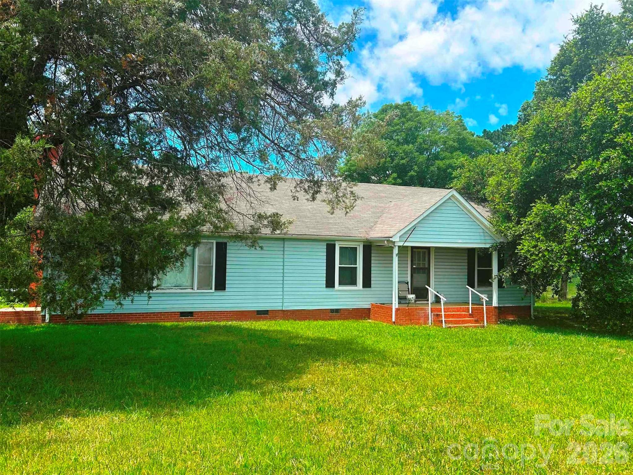 EXCELLENT OPPORTUNITY. Spacious 3-bedroom, 2.5-bath single-family home in Peachland, a peaceful rural town just 45 minutes from CHARLOTTE. Offering just under 3,000 sq. ft. of living space on nearly 1 ACRE, the property overlooks WOODS and FARMLAND with room to spread out and breathe. This is an opportunity for an OWNER-OCCUPANT ready to build sweat equity, or a FIX-and FLIP INVESTOR who sees broken garage doors, clutter, missing siding, and the NEED FOR RENOVATION and updating, then looks at the location and comparable sales and thinks MASSIVE POTENTIAL. Listed at the cash, as-is QUICK SALE price point, it leaves SIGNIFICANT UPSIDE. Alternatively, the seller is open to completing updates at a negotiated higher price point. Request your showing today.