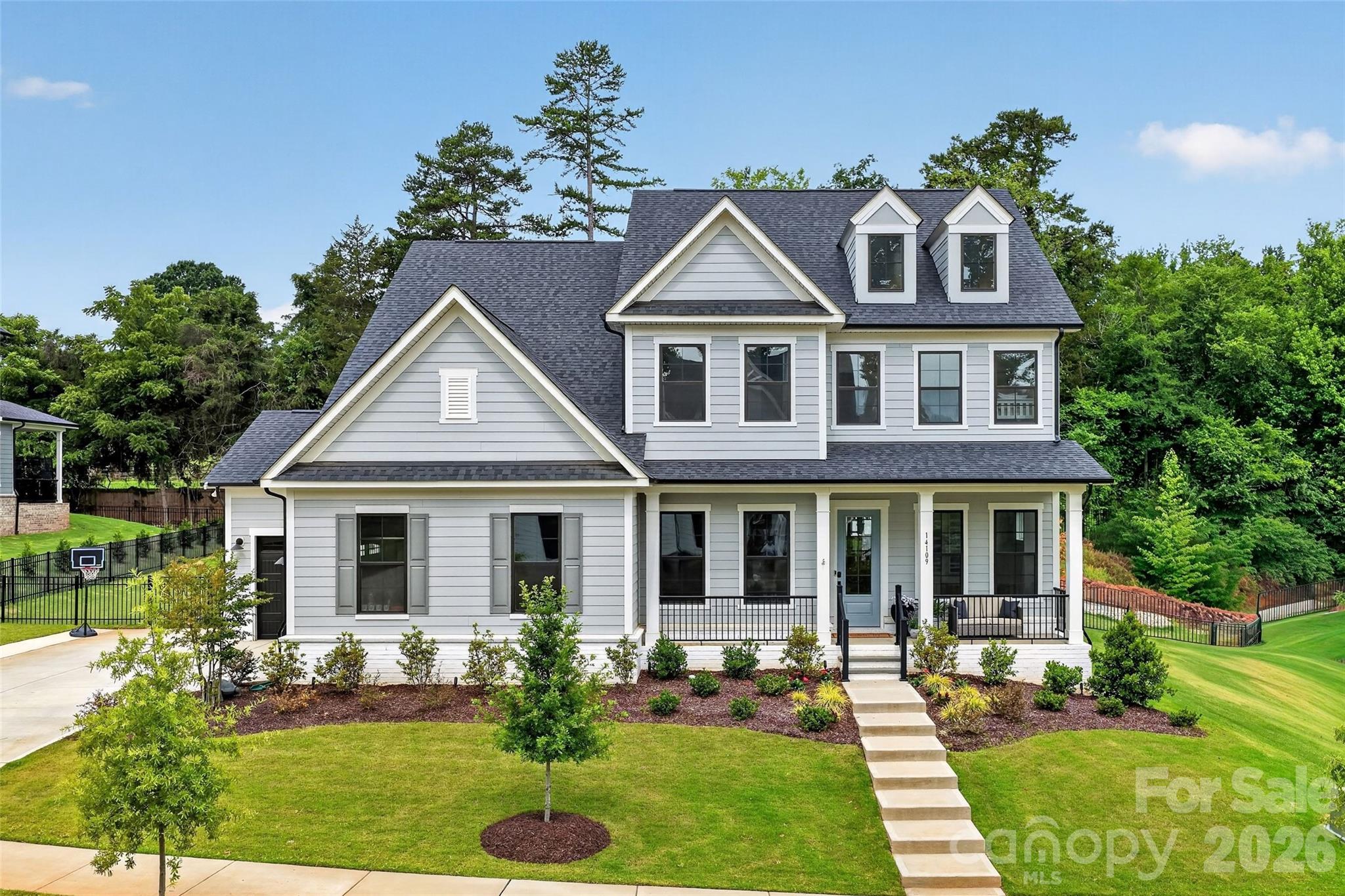 LOCATION! This flat, private 0.33-acre homesite offers rare space and usability, backing to a wooded tree line and peaceful horse pasture. Enjoy the perfect blend of privacy and convenience—just 7 minutes from Target & I-77, walking distance to NorthStone Country Club, and only 10 minutes to Birkdale Village. Completed in 2025, this thoughtfully designed home features an open-concept layout and expansive stacking glass doors that seamlessly blend indoor and outdoor living leading to a screened porch with large stone gas fireplace that overlooks a fenced backyard with extended patio. Additional upgrades include a bright sunroom, beverage fridge, custom vent hood, dual dishwashers, drop zone, and oversized 3-car garage. A main-level guest suite with full bath provides ideal flexibility for multigenerational living, guests, or a private office. Upstairs, the luxurious primary suite is a true retreat with separate his-and-hers custom walk-in closets plus 4 more bedrooms and 2 full baths. Must see! Some photos have been digitally enhanced.