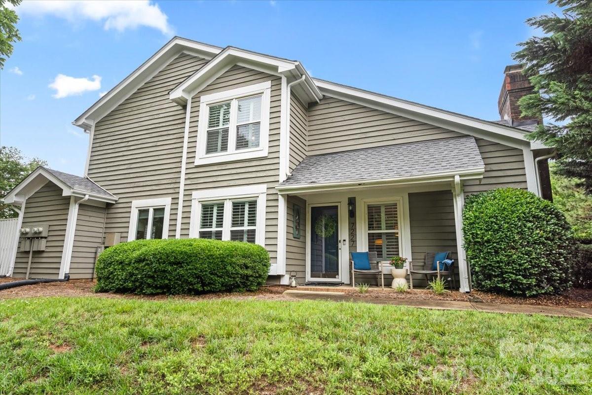 Tucked away in a private corner in this community, you'll find this updated end-unit condo with a one-car garage in highly sought-after The Gates at Quail Hollow! A charming rocking chair front porch welcomes you into this light-filled home featuring a dramatic two-story whitewashed brick fireplace, hardwoods on the main level and stairs and plantation shutters throughout. The beautifully renovated kitchen (2017) boasts granite countertops, tile backsplash, custom cabinetry and stainless steel appliances. A stylish wet bar adds the perfect touch for entertaining while also providing additional storage. Open staircase overlooks the living room. A spacious primary suite features dual closets, dual vanity and a walk-in shower. Enjoy outdoor living on the enclosed private patio and raised deck. Major updates include new windows (2021) and HVAC (2017). Good storage throughout. Resort-style community amenities include a pool, hot tub, fitness center, clubhouse, tennis court and Chimney Park - the perfect spot to picnic. Private tree lined street and lots of green space is a dog lovers dream - great for walks! Conveniently located near SouthPark, Sharon West light rail, Uptown and major interstates. Community is within walking distance to shopping and restaurants. HOA dues include water, exterior maintenance, roads/parking spots, landscaping and amenities.