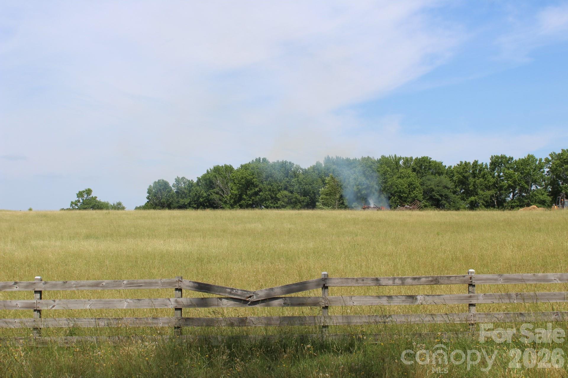 "Raintree Farms" - a beautiful and scenic development about 15 minutes from hustling & bustling towns like Chesnee, Boiling Springs, Landrum, and Tryon - situated about a mile from the SC / NC state line, off of Chesnee HWY and very close to HWY 11.  **LOT 8 is nestled privately in the back corner just below one of the large red barns (Lot 9).  A very private lot ... a very nice setting for a home.  **  Raintree Farm was a 64 acre cattle farm with 2 large red barns and has been recently subdivided into 2 - 6 acre lots to create manageable "Farmettes" for people who want to live outside of the city, but not be too far away to "run to the store".  The lots will allow you to have livestock (horses, goats, chickens) or grow an amazing garden, without any HOA dues or restrictions.  The only restriction that will be implemented is "no mobile homes".  Many of the lots will have views of the barns or mountains.  As you stand on one of the lots, you feel the warm breeze in your hair and all you hear are the birds & crickets!  As municipalities continue to implement more and more restrictions, Lots like these are harder and harder to find.  Bring your vision & come claim your Piece of America - Amber waves of Grain - Peaceful Country Living -!   Buried High Speed Internet Available.  REMC Power Available.  Call With Questions!!