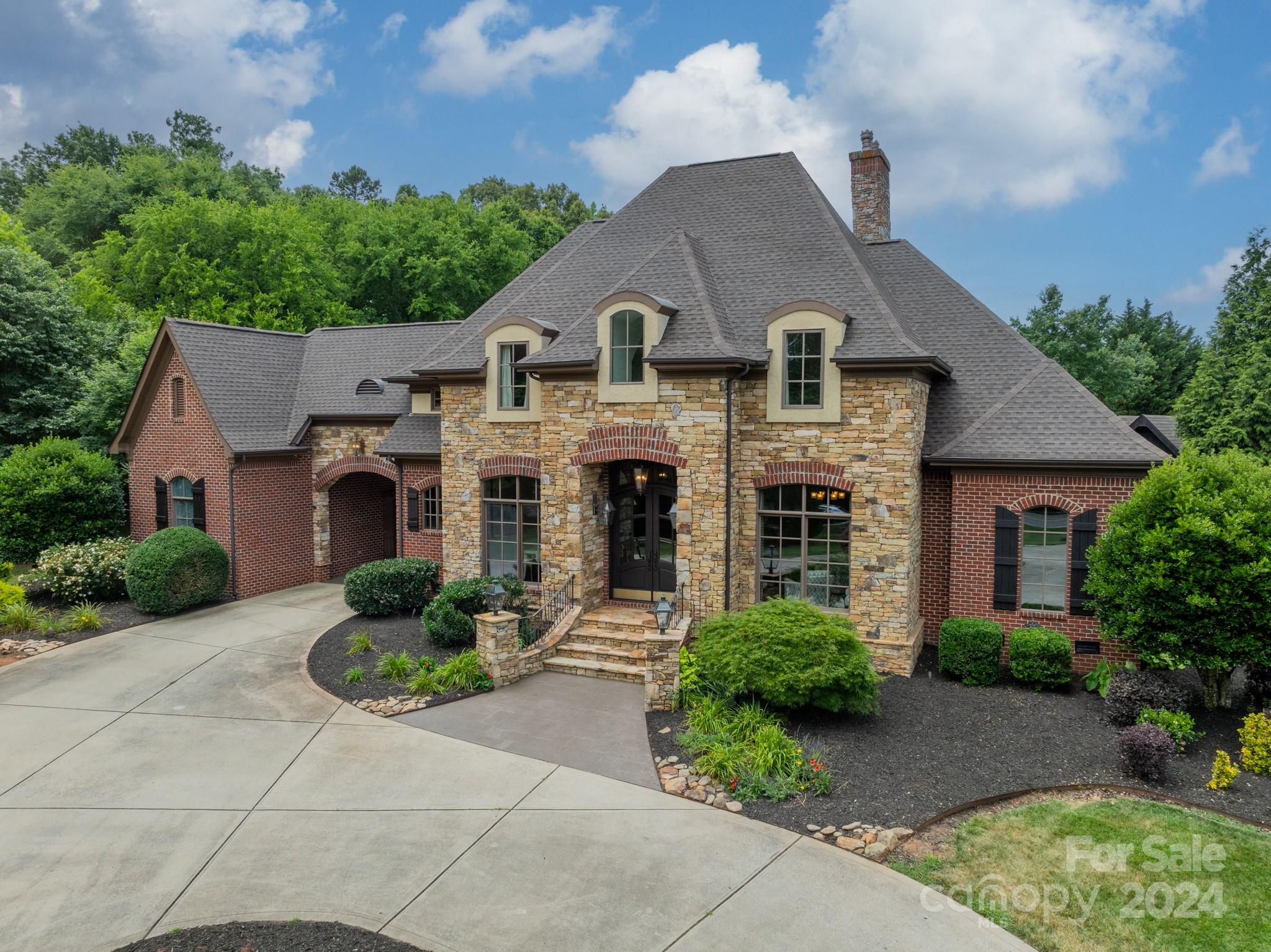 Step into refined luxury & contemporary updates at this iconic custom estate in Union County.This exquisite residence offers unparalleled opulence & sophistication w/custom trim work and quality finishes at every turn. This beautiful home has tremendous curb appeal w/its courtyard driveway, porte cochere w/motor court, fabulous entry way w/gas lanterns and elegant arched french doors.The interior features an open floor plan w/high ceilings,updated kitchen w/custom cabinetry,quartz countertops,high-end appliances,beautiful hardwood floors and neutral paint.The main level features primary bedroom w/architectural ceilings,spa-like bath,custom closet, guest bedroom w/ensuite,laundry room w/custom cabinetry, office w/coffered ceiling/custom pocket doors. Upstairs includes two bedrooms w/ensuites,flex room,bonus room w/veranda overlooking the saltwater pool,cabana w/fireplace and serene lush grounds.No HOA/HVAC 2023/Roof 2024.This property epitomizes luxury and craftsmanship in every detail.