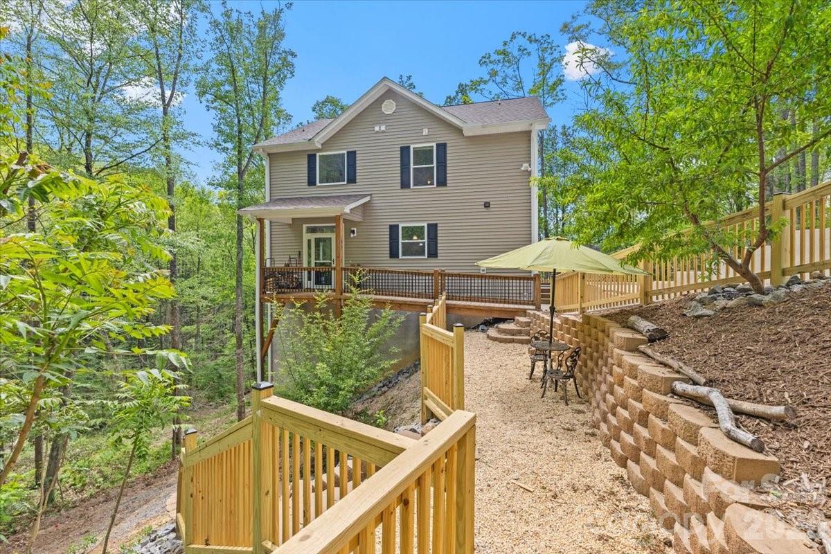 Tucked away at the end of a private cul-de-sac in the mountains of Swannanoa, custom built 65 Leisure Lane offers a rare blend of privacy, long-range mountain views, flexible living space, and thoughtful upgrades—all surrounded by the natural beauty Western North Carolina is known for. With abundant wildlife, peaceful wooded surroundings, and minimal through traffic, this property delivers the kind of quiet mountain lifestyle buyers are actively searching for—while still keeping you conveniently connected to everyday amenities.

The outdoor living experience is exceptional. A custom reinforced steel walkway provides both durability and architectural appeal, while extensive retaining walls with concrete footers add long-term structural value. Enjoy evenings under the stars on the custom terrace featuring a swing and BBQ area, perfect for entertaining family and guests. The property also offers a unique homestead feel with producing plum, apple, peach, nectarine, and additional fruit trees throughout the grounds. A new concrete driveway has already been designed to accommodate a future detached garage, and sellers will convey their garage building plans—giving buyers immediate expansion potential.

Inside, the main level welcomes you with warm mountain charm, highlighted by a wood-burning fireplace in the family room, creating the perfect gathering space during cooler mountain evenings. The kitchen comes fully equipped with appliances that convey, making this home truly move-in ready. Upstairs, you’ll find new carpet, 3 bedrooms and 2 bathrooms, with a private primary suite featuring a secluded veranda with breathtaking mountain views—the ideal place for morning coffee or sunset relaxation.

The home’s fully permitted finished basement creates incredible versatility with a full bathroom, bonus rooms, USB receptacles, and pre-wiring/plumbing already in place for an additional kitchen setup, offering ideal potential for multigenerational living, guest quarters, rental income possibilities, or a private home office suite. An additional sub-basement storage area provides even more functional space for outdoor gear, seasonal storage, or workshop needs. For added peace of mind, the home also includes a transferable home warranty.

Beyond the property itself, the location is a major draw. You’re positioned just minutes from charming downtown Black Mountain—known for its restaurants, boutiques, galleries, and scenic Swannanoa Valley Museum & History Center—and only about 15 miles from vibrant downtown Asheville, offering easy access to dining, healthcare, shopping, and entertainment. Outdoor enthusiasts will love being close to Blue Ridge Parkway - Craggy Gardens Visitor Center, Craggy Gardens, Tanbark Ridge Overlook, and Charles D Owen Park for hiking, biking, picnicking, and exploring the Blue Ridge Mountains. Families will also appreciate proximity to schools such as W.D. Williams Elementary School, Charles D. Owen Middle School, and Asheville Christian Academy.

This is more than just a home—it’s a private mountain retreat offering lifestyle, flexibility, and long-term value in one of Western North Carolina’s most desirable areas. 

All information derived from seller and public records systems, and is deemed reliable, but not guaranteed. Buyers and buyers' agents responsible to verify.