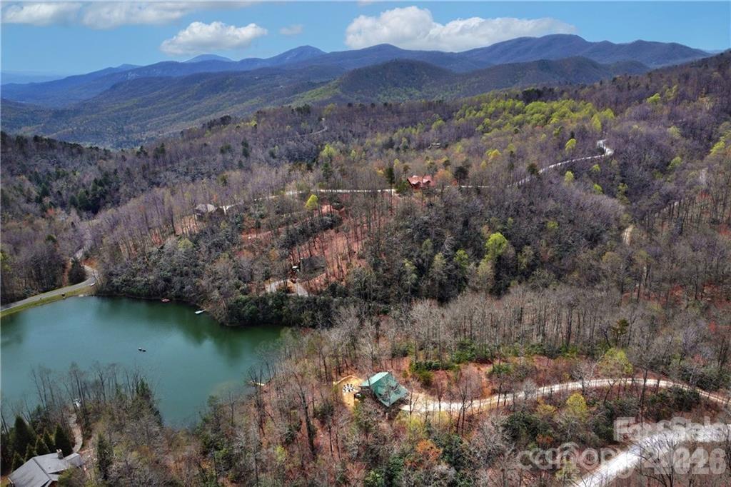 Fully furnished lakefront mountain retreat in the sought-after Gateway Mountain community! Nestled on 1.9 acres, this gated community spans over 3,000 acres and allows short-term rentals, making it an excellent opportunity for a vacation home or income-producing rental. Overlooking serene Lake George, the property features a private dock, tool shed, and a stunning firepit area with a gravel path and steps to the water. Extensive 2022 upgrades include quartz countertops, stainless steel appliances, updated bathroom fixtures, and stylish light fixtures and ceiling fans throughout. The fully stocked kitchen and furnished interiors make this home truly turnkey. Enjoy the peaceful mountain setting while being minutes from adventure. Don’t miss this rare opportunity—schedule your showing today!