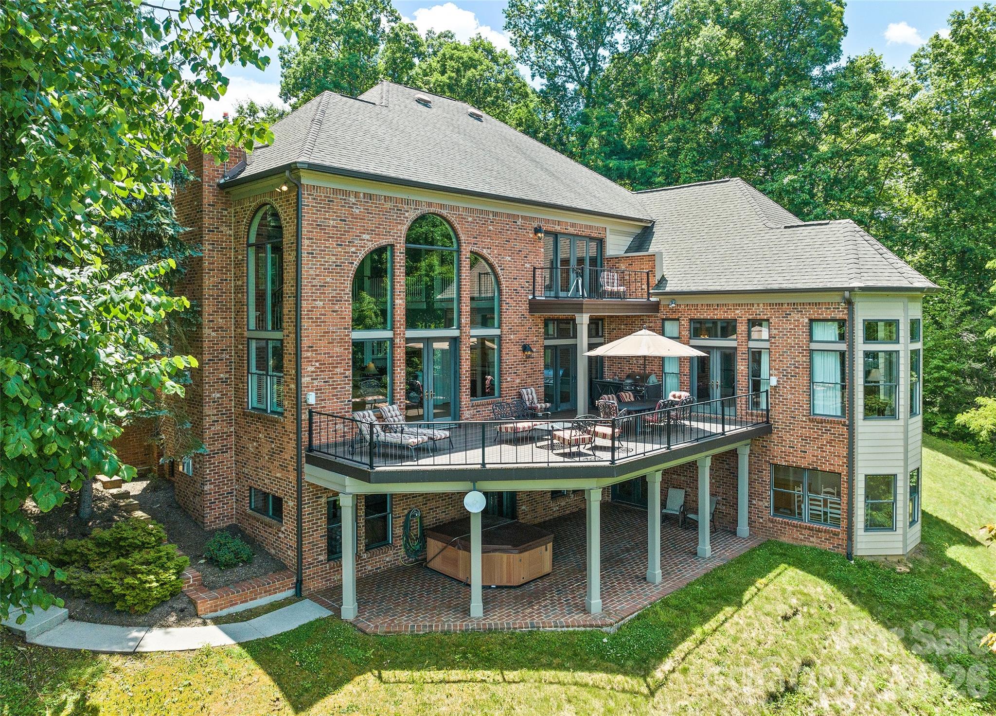 Perched gracefully above the Maggie Valley Country Club, this exquisite 2-story Arts & Crafts masterpiece with fully finished walk out basement, offers an unparalleled mountain lifestyle on 1.32 acres. Boasting breathtaking, long-range views, this 4-bedroom, 4-full, and 2-half bath estate combines luxury with easy accessibility via fully paved roads.

Step inside to the main level where dramatic, soaring coffered ceilings and a magnificent wall of windows frame the stunning mountain views. The large, main-level primary suite is a true sanctuary, featuring a sitting area and floor to ceiling windows designed to let you wake up to the views. For ultimate convenience across all three levels, the home features a private elevator.

The fully finished lower walk-out level is a phenomenal asset, perfectly designed to function as a completely separate living space or a premier entertainment hub. Boasting its own private exterior entrance, it features a large family room, a second full kitchen, a wet bar, a pool table area, a workout space, plus a bedroom and full bath.

Enjoy the country club lifestyle with golf, dining, and resort-style amenities just moments away. For ultimate privacy or future development, four additional surrounding lots are available for separate purchase. A rare find in Maggie Valley!