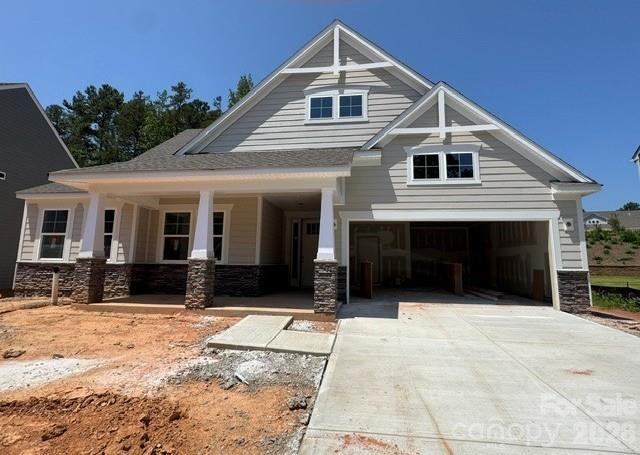 This 1.5-story Sullivan offers 4 bedrooms, 3.5 baths, and more than 2,700 square feet of living space. The main floor has more than 2,100 square feet and includes primary suite with tray ceiling and luxury shower, two additional bedrooms, an office with French doors, a mud room with drop zone, a half bath, and laundry room with cabinets and a sink. The family room/kitchen/breakfast area is a wonderful gathering space. The designer kitchen features white cabinets with a contrasting island, quartz counters, tile backsplash, a shiplap range hood, and stainless appliances, including a gas cooktop. The upper floor has a large loft, along with a bedroom and full bath with tub/shower combo. The rear of the home features a spacious covered porch. Other extras include a foyer with tray ceiling, tankless water heater, and Craftsman-style wood trim. Visit today!