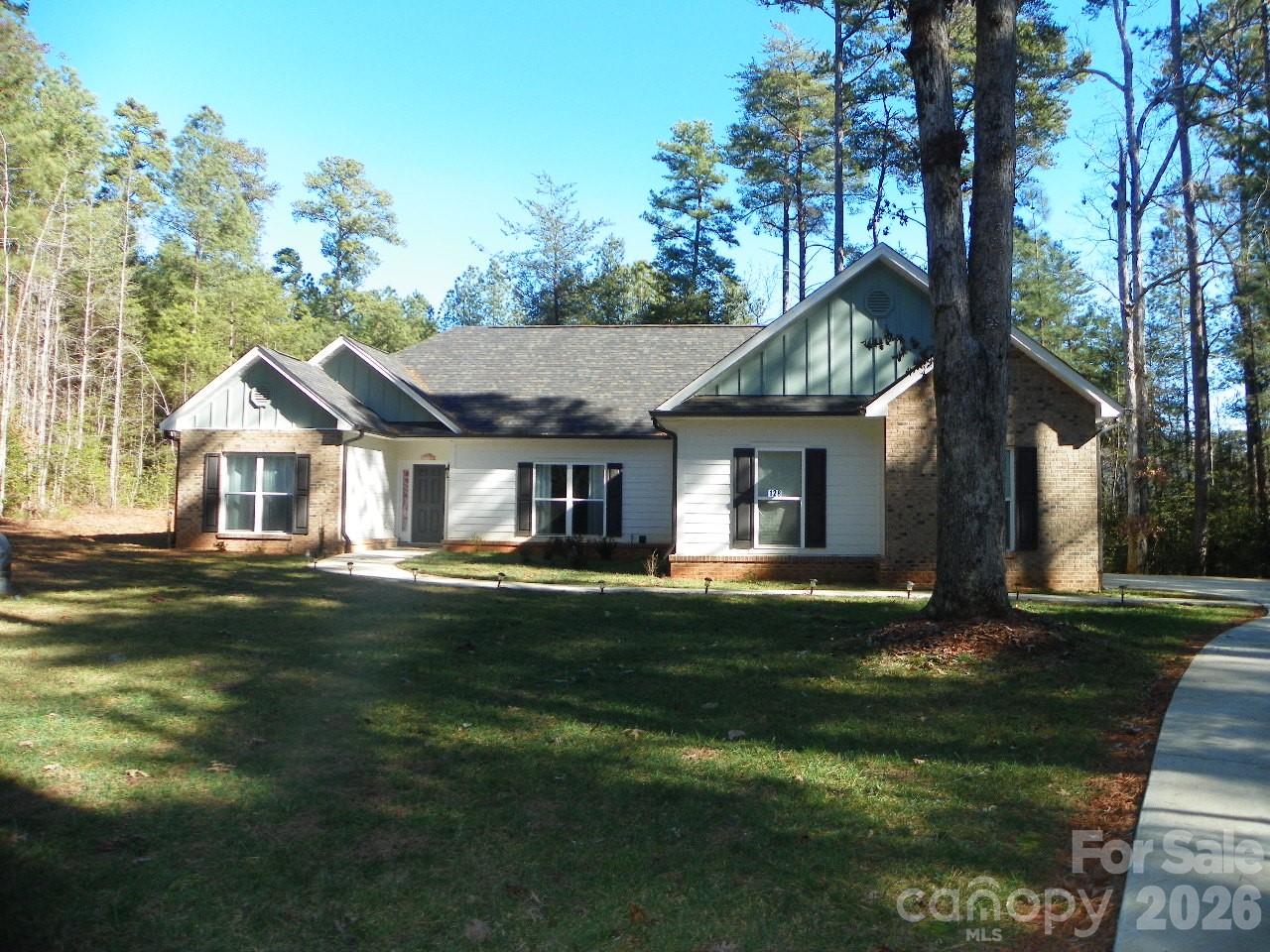 JUST MIGHT BE THE RIGHT ONE FOR YOU!!  Near the entrance on .89 Ac flat lot,  near the Clubhouse, boat launch area, nice large flat yard.  Nice open concept- Kitchen, dining, LR. Paved driveway and walkway, 2 car attached garage. Nice covered back porch for relaxation and peacefulness. Taking --Washer/Dryer, refrigerator and all small appliances. The beautiful gated community of Heron Bay invites you to visit and see up close what they have to offer!!  Private, peaceful with rolling hills all paved streets  with Lantern lit street lights, community boat launch, beautiful Clubhouse with beautiful wraparound covered porch. Clubhouse available to Owners for reserve.  Boat/RV storage available for a small fee. Community Pickleball area just across the street from the Clubhouse. Walking trails for your enjoyment.  Must see all this to appreciate it!!!