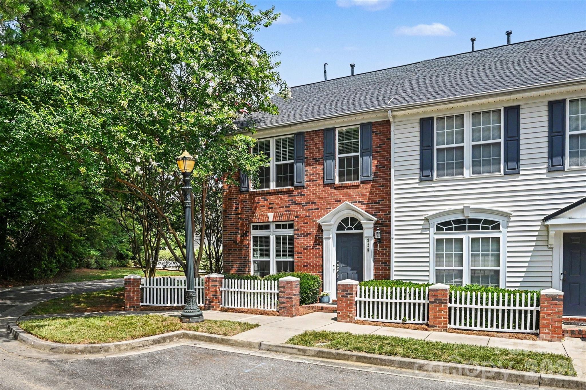 Beautifully updated and filled with natural light, this end-unit townhome offers the largest floorplan in the community, making it one you won't want to miss. Featuring 2 bedrooms and 2.5 bathrooms, this home combines comfort, style, and functionality in a highly desirable setting, with numerous recent improvements that make it easy to move in and enjoy from day one. Upon entry, you'll notice the thoughtfully designed living space showcasing expansive windows, updated flooring, and a spacious main living room. Unique to this floorplan is a versatile year-round sunroom, providing the perfect flex space for a home office, reading room, plant nook or fitness space. In the kitchen, you'll enjoy ample cabinetry, new hardware, all the appliances that convey, a breakfast bar with seating, as well as and a dedicated dining room. Upstairs, the spacious primary suite features an en-suite bath and generous walk-in closet, while the secondary bedroom also offers its own private full bath, creating an ideal layout for guests or roommates. Step outside to enjoy two dedicated rear parking spaces, an attached storage room, and your own built-in planter box, perfect for fresh herbs, seasonal flowers, or a small vegetable garden. Hosting is effortless with abundant street parking for family and friends. This home has been thoughtfully upgraded with all new windows (2025), updated foyer and hallway lighting (2025), new upstairs flooring (2024), all new toilets (2024), new bedroom ceiling fans (2024), updated door hardware throughout (2024), keyless entry (2024), new exterior storage door (2024), attic vent (2024), tankless water heater and new water lines (2021), and a new furnace (2022), allowing the next owner to move in with confidence. Residents enjoy a neighborhood pool, sidewalks, and streetlights, all while being just seconds from I-77, Target, HomeGoods, grocery stores, restaurants, and everyday conveniences. Only 30 minutes from Uptown Charlotte and Charlotte Douglas International Airport, this location offers the perfect balance of accessibility and neighborhood charm. Move-in ready and beautifully maintained, this exceptional end-unit is the one you've been waiting for.