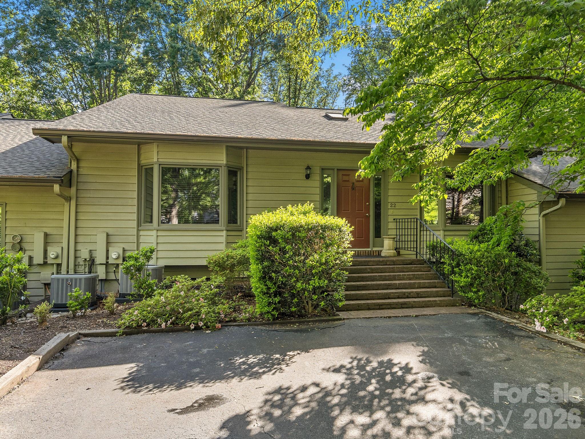 Located in Tryon's Hunting Country, this two-level townhome offers 2,672 square feet with a thoughtful layout and well-executed finishes.
Hardwood floors, a wrought iron staircase, hammered copper sinks, and two fireplaces give the home a warm, established feel. The upper level is centered around the main living spaces, including a spacious primary suite, formal dining area, and a well-appointed kitchen.
The lower level provides additional living space with a large family room, private office, second bedroom, and access to a screened porch and covered patio set into the wooded hillside. It creates a natural separation for guests or extended use.
The HOA manages exterior maintenance, allowing for a more low-maintenance lifestyle. Convenient to both Tryon and Landrum, the location offers easy access while still feeling quiet and private.
Quiet, private, and well-finished — in one of Tryon's most established settings.