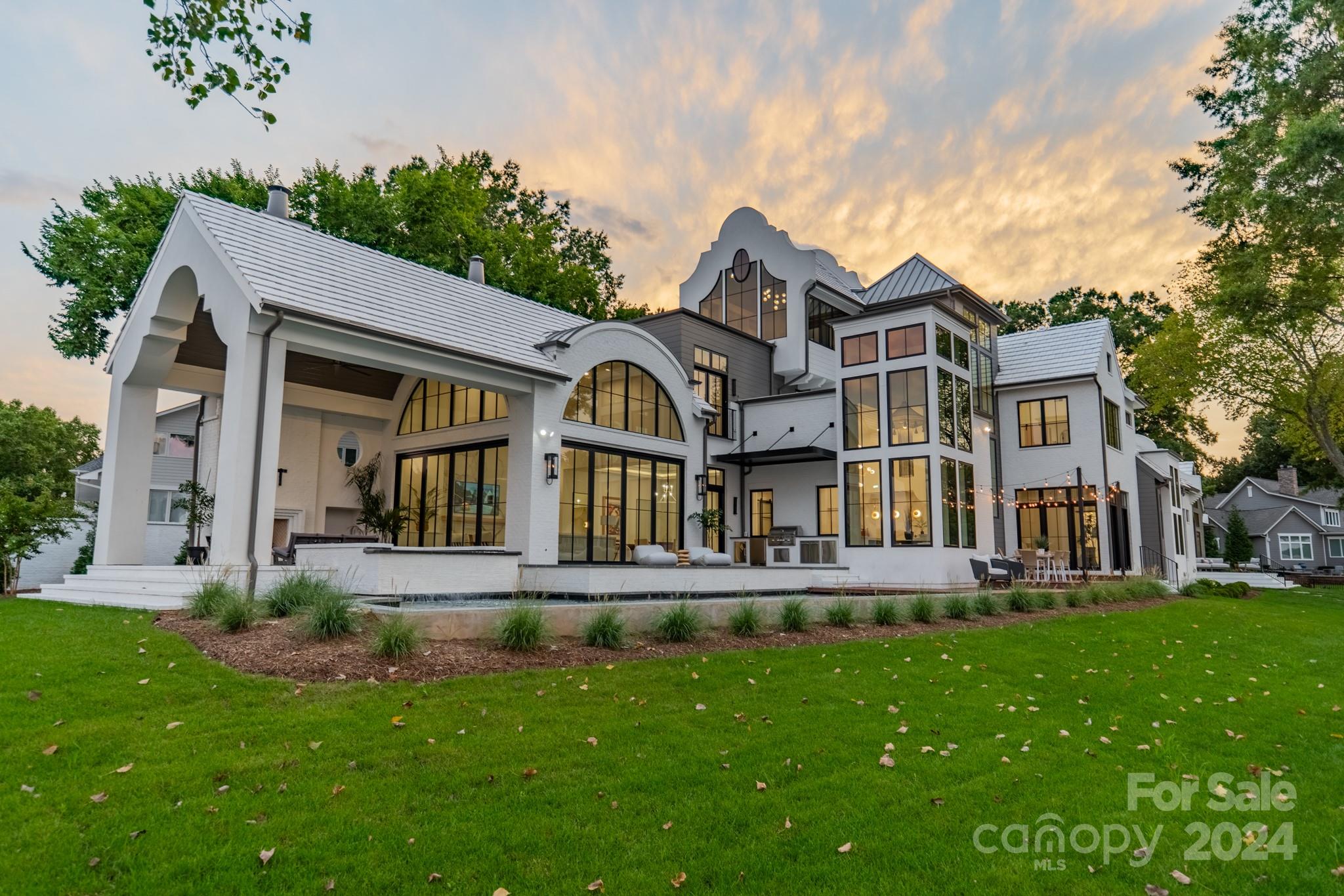 Welcome to Whispering Oaks, a modern estate designed by Elite Design Group and built by Grandfather Homes, that over looks 300' of waterfront on Lake Norman with a sandy beach just inside the no wake zone on open water. With more than 9,700 sf under roof, the design vision for this property is firmly grounded in a contemporary coastal aesthetic with a transitional flair, and an emphasis on texture and graphic contrast that is meant to stand the test of time. With interior design by Modern Cottage, the custom curated features that adorn every corner encourage both inspiration and respite for all dwelling within its walls. It pioneers a worldly aesthetic in a functional way, blurring the lines between indoor and outdoor to create a lakeside estate that is equally ideal for both a serene escape, and elevated yet relaxed entertaining.