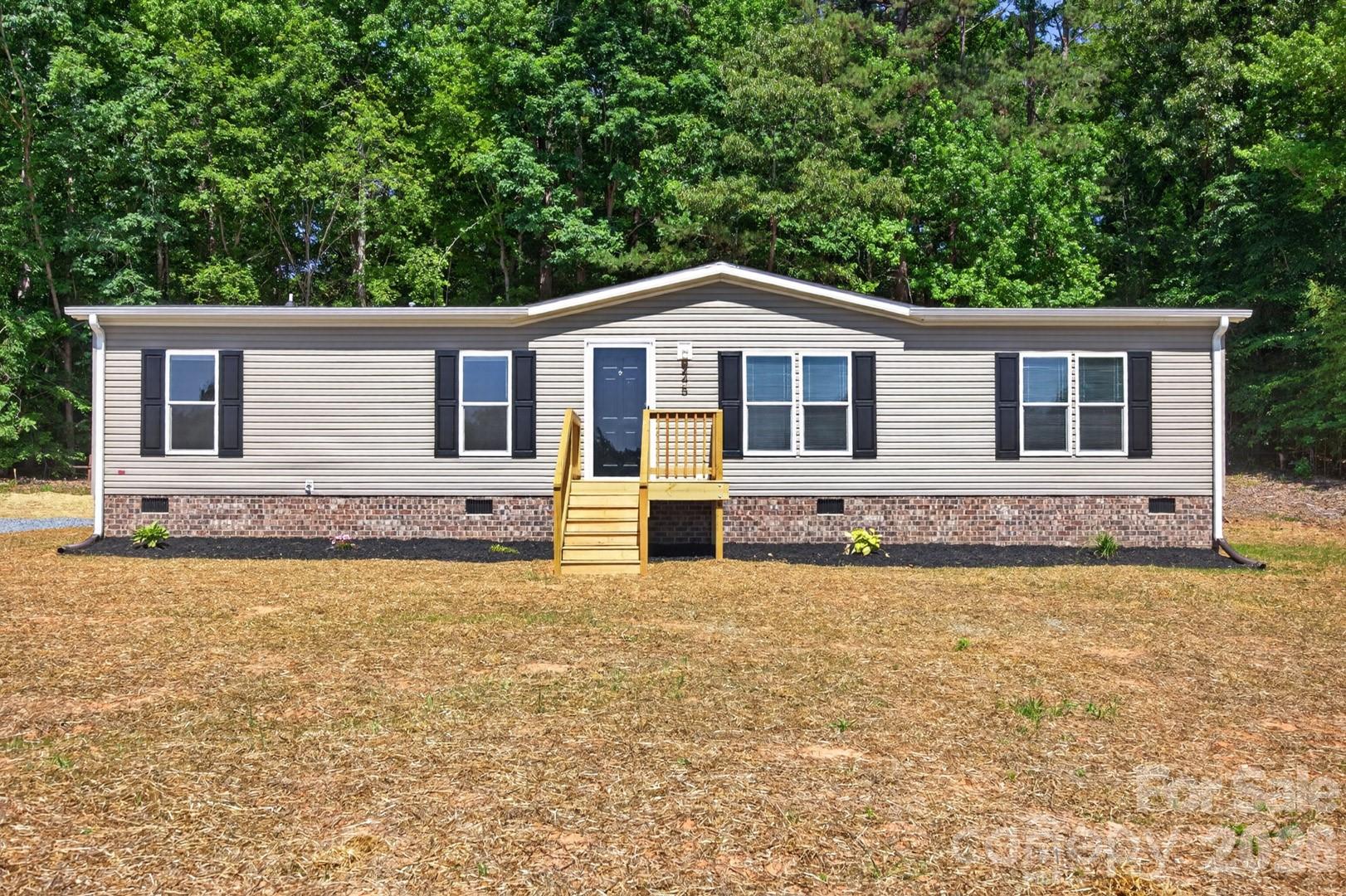 Welcome to this newly built 3-bedroom, 2-bath home set on nearly 3/4 of an acre with plenty of space inside and out.  The open-concept floor plan features a comfortable living area that leads into a well-appointed kitchen with stainless steel appliances, a center island, and an eat-in dining area. A spacious den off the kitchen offers extra room for entertaining, relaxing, or creating a flex space to fit your needs. The primary suite provides a private retreat with a garden tub, separate shower, and ample closet space. Two additional bedrooms and a large utility room add functionality and convenience. Outside, enjoy the oversized back deck overlooking the peaceful backyard. Ideally located near High Rock Lake for easy access to boating, fishing, and recreation.