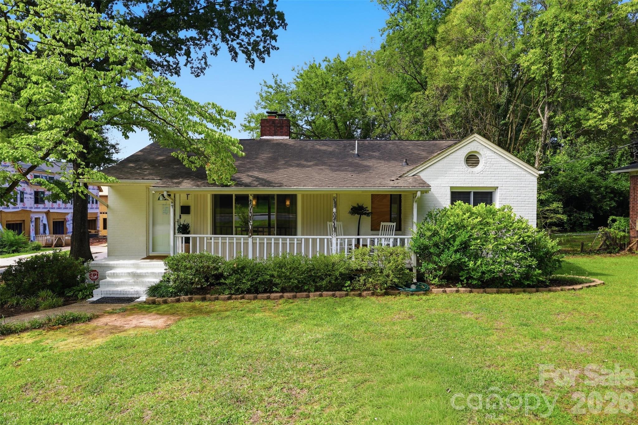 Charming mid-century brick bungalow ideally positioned in the highly sought-after Country Club Heights, a rapidly appreciating enclave nestled between NoDa’s light rail and Plaza Midwood. Situated on a generous 0.33 acre corner lot with no HOA, this property offers both privacy and flexibility, complemented by a partially fenced yard and inviting curb appeal. A spacious, covered rocking chair front porch welcomes you inside, where timeless hardwood floors flow throughout the sun-drenched living room and all three bedrooms.

The kitchen features stainless steel appliances, a 5-burner gas range, tile flooring and a stylish tile backsplash, while custom built-ins throughout the home provide thoughtful storage solutions. The fully renovated bathroom showcases a sleek, modern design with a floating vanity and an expansive, tiled walk-in shower.

Outdoor living is equally appealing, with a level and lush backyard. Located just a short distance from Shamrock Park and moments from some of Charlotte’s most vibrant dining, shopping, and entertainment destinations, this home seamlessly blends classic charm with modern convenience!