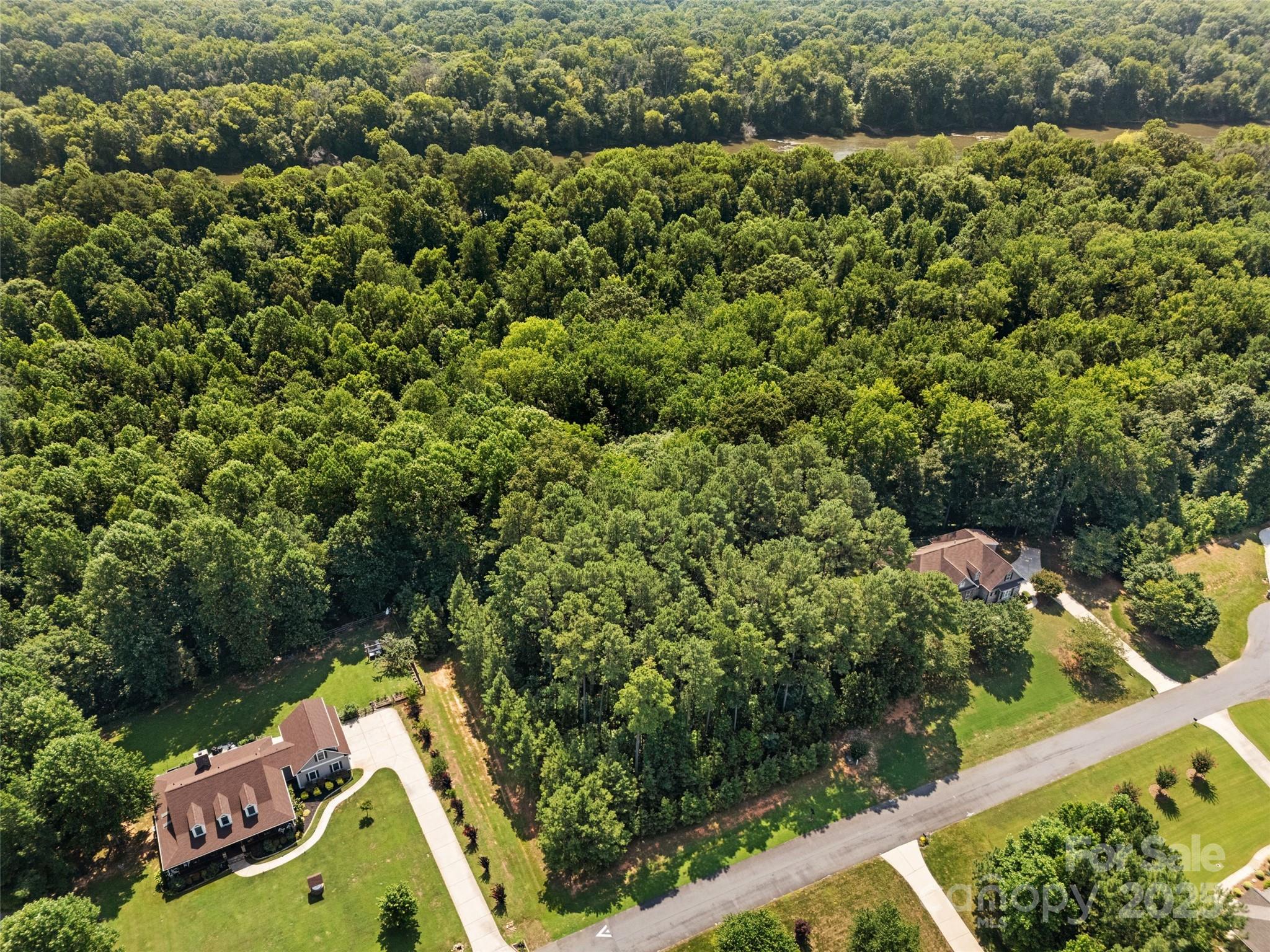 Rare opportunity to build your dream home in the desirable Catawba Shores Estates community. This 1.12-acre private lot is ideally situated at the back of the neighborhood and next to a quite cul-de-sac, offering added privacy and peace of mind—no one can build behind you. Enjoy the natural beauty of the surroundings with seasonal views of the Catawba River, mature trees, and a serene setting. The gently sloping lot provides a versatile building envelope perfect for a custom home. Neighborhood amenities include river access, walking trails, and a peaceful, well-maintained environment just minutes from downtown Rock Hill and I-77. Don’t miss your chance to own a spacious lot in one of Rock Hill’s most sought-after communities.