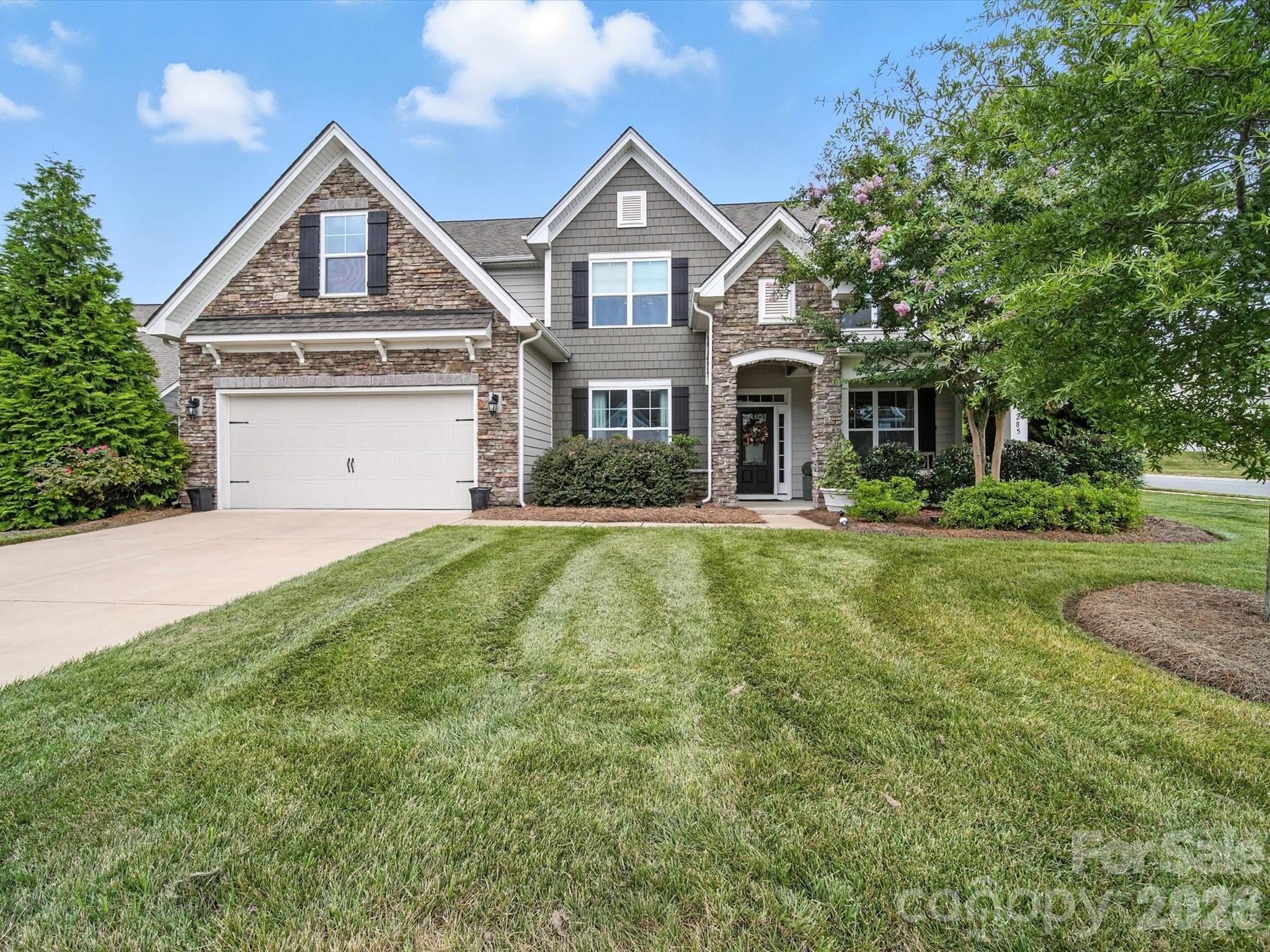 Former model home with designer details throughout! This open floorplan offers a dedicated office with glass French doors, elegant dining room with coffered ceiling, spacious family room with gas fireplace and built-ins, and a sunroom off the kitchen. The gourmet kitchen features quartz counters, tile backsplash, stainless steel appliances including gas cooktop, wall oven, microwave, dishwasher, and counter-depth refrigerator, plus a butler’s pantry and drop zone. Main level guest suite with full bath. Upstairs you’ll find a luxurious primary suite, three additional bedrooms, and a large bonus room. Outdoor living shines with a paver patio, sitting wall, and firepit. Resort-style community amenities and a prime location near Ballantyne conveniences with low Lancaster County taxes!