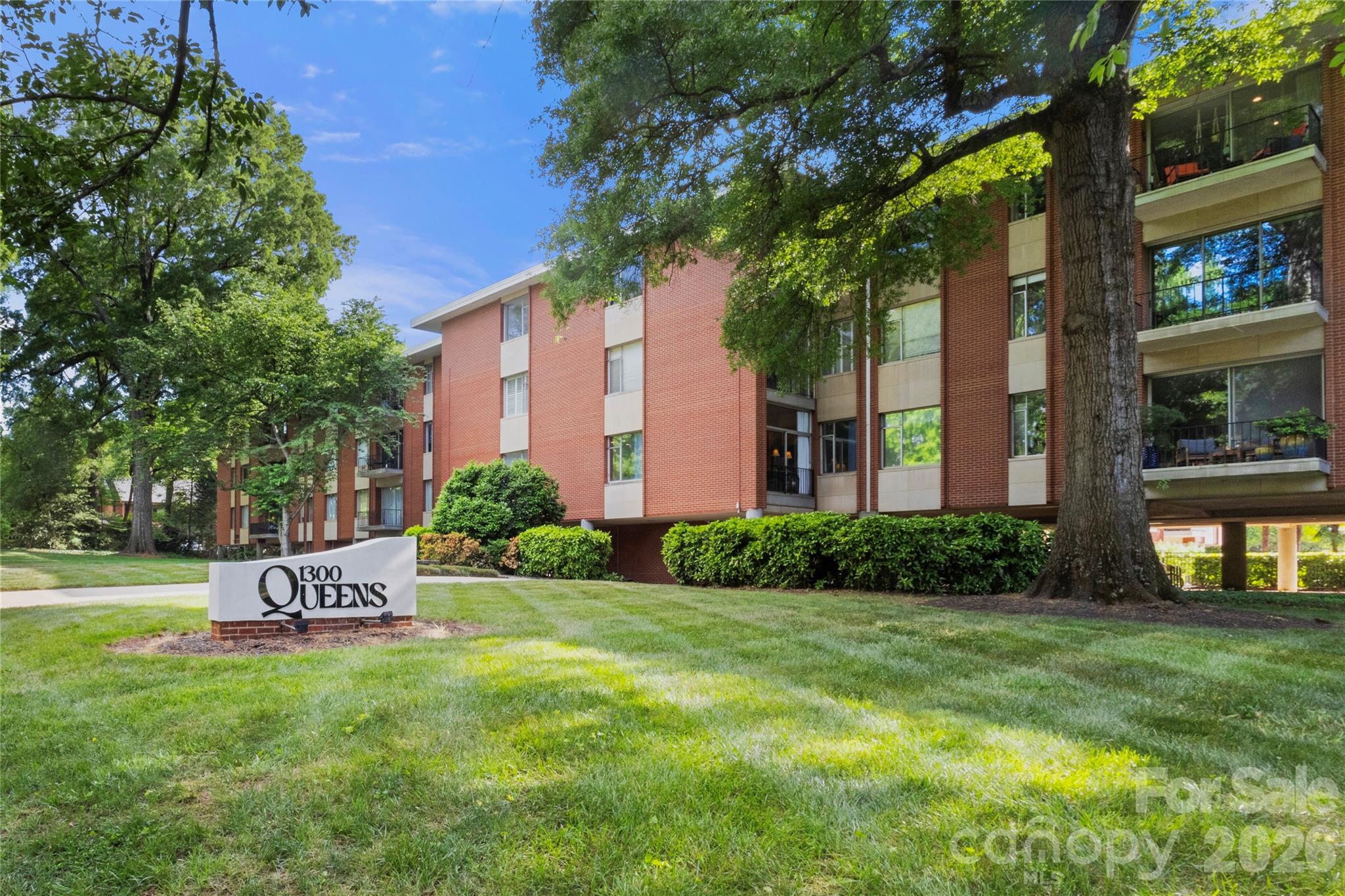 Queens Towers condo blending classic mid-century character with modern updates in an unbeatable location near Uptown, Myers Park, Dilworth, Queens University, and Midtown. Rare 3-bedroom, 2-bath corner unit filled with natural light and featuring hardwood floors throughout—no carpet. Updated kitchen with modern appliances and a functional layout. Large sliding glass doors open to a private balcony, creating an easy indoor-outdoor flow. Includes one covered parking space plus an additional open spot. Community laundry is conveniently located in the building. Enjoy the outdoor pool and gas grilling area. HOA covers an extensive list of utilities and services including electric, water, sewer, internet, cable, trash, exterior maintenance, landscaping, parking, pool, and grills—offering easy, low-maintenance living.
