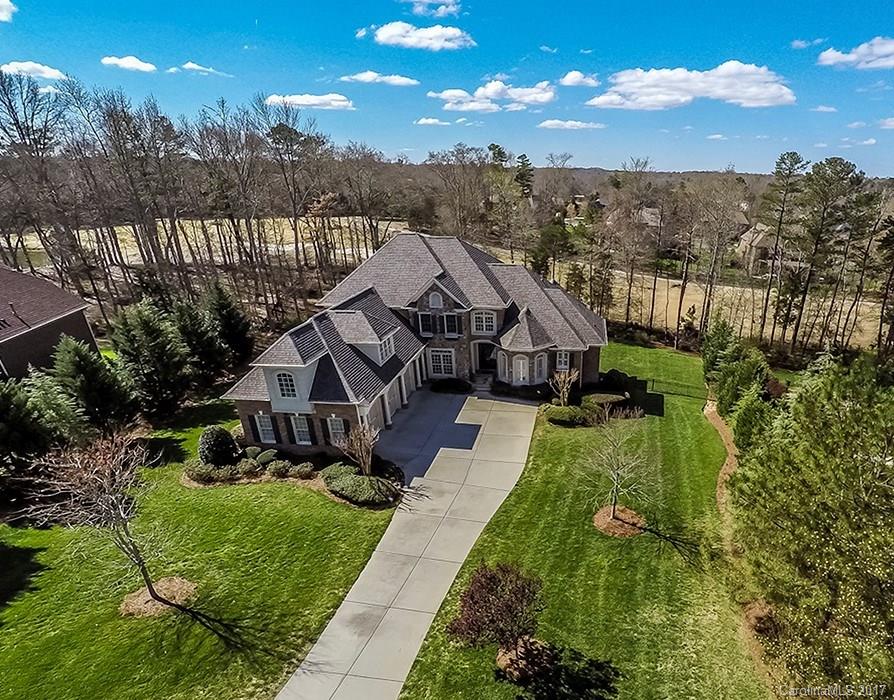 Stunning & Spacious Brick/Stone/Stucco Estate with exceptional Golf Course views & amazing Entertain Spaces inside & out. On cul-de-sac street. Soaring 20' Living Room w/vaulted ceilng & abund. light from window wall. Huge Chef's Kitchen & B'fast w/adjoin Vaulted Hearthroom. Master Suite & Guest Suite on Main. Huge Lowr Lvl Entertain/Living/Kitchen PLUS 1,100+ Unfin sf. Builtins galore, Surr. Sound. Great Outdr Areas, FP & Fenced Yd. Close to Ballantyne & Blakeney shops/restaurnts. Low SC Taxes.