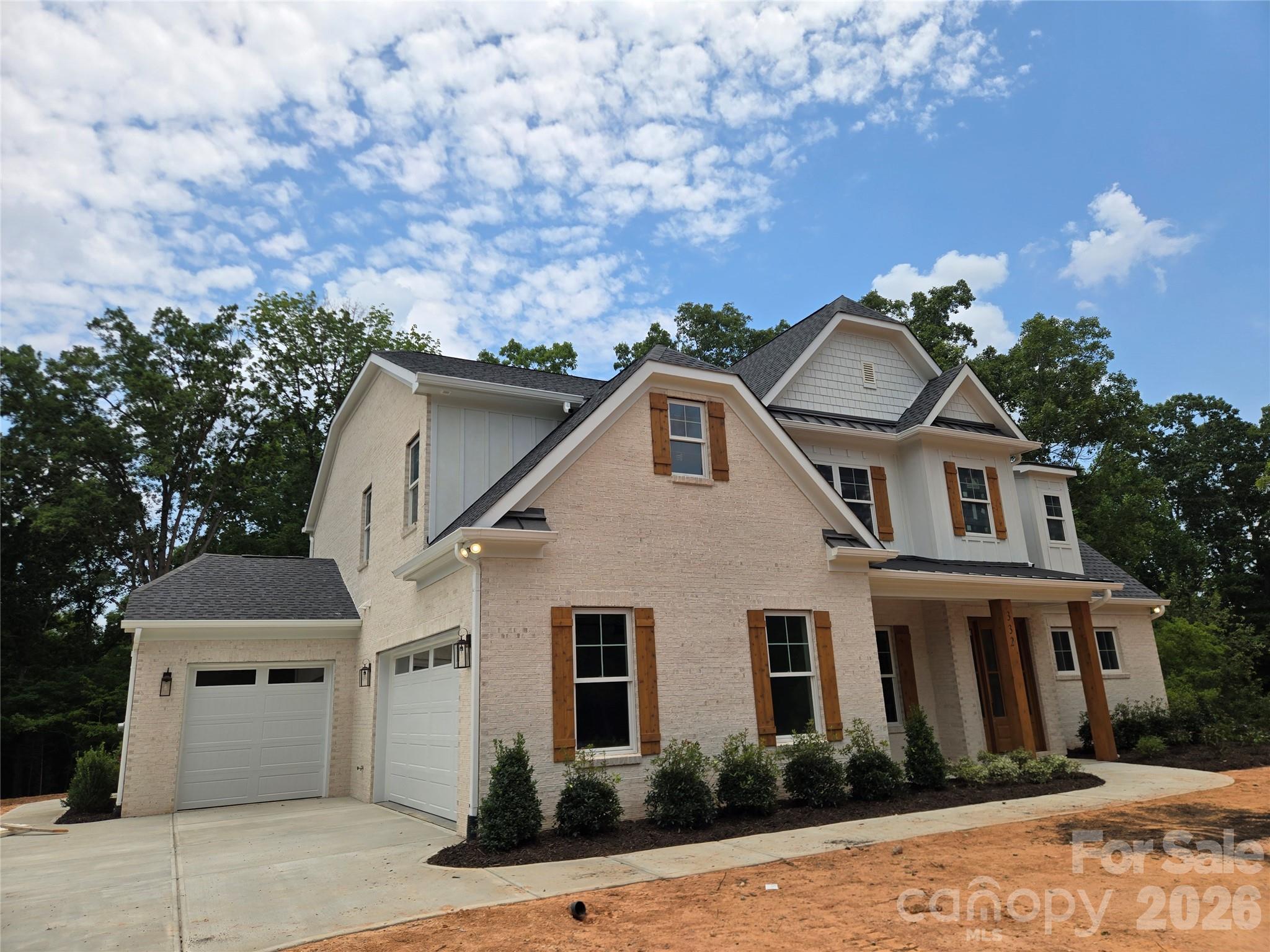 STUNNING NEW CUSTOM-BUILT ESTATE ON 2.14 ACRES IN PRIME INDIAN LAND LOCATION! Welcome to this masterfully crafted, new construction custom home where no detail has been overlooked and top-end finishes shine throughout. Situated on a private 2.14-acre lot, this property perfectly blends the peace of acreage living with unparalleled suburban convenience. GRAND ARCHITECTURAL ENTRYWAY & ELEVATED DESIGN: From the moment you arrive, the exceptional curb appeal and welcoming rocking-chair front porch set a luxurious tone. Step through the front door into a spectacular, grand two-story foyer. This dramatic entrance is completely dressed in extensive custom molding and anchored by a magnificent statement light fixture. Soaring 8-foot doors throughout the main level instantly amplify the home's grand scale and custom craftsmanship. ELEGANT MAIN LEVEL LIVING & ENTERTAINING: Just off the foyer, the formal dining room serves as a perfect backdrop for gatherings, highlighted by an elegant coffered ceiling. The heart of the home is the expansive great room, which features its own stunning coffered ceiling. Designed for modern living, this space flows effortlessly into the dining area and a true chef’s dream kitchen. GOURMET CHEF'S KITCHEN WITH PREMIUM UPGRADES: The gourmet kitchen is loaded with high-end, designer-grade finishes, including: A massive center island featuring a striking quartz waterfall edge and bar seaing. Premium ZLINE appliances, anchored by a professional-grade 48-inch gas dual oven range. Striking quartz countertops seamlessly paired with a matching full-height quartz backsplash, Pristine white cabinetry featuring custom glass accent doors and soft-close hardware. Sophisticated under-cabinet lighting that beautifully illuminates the workspaces, A deep walk-in pantry offering incredible storage space. MAIN-LEVEL PRIMARY RETREAT: Tucked away for ultimate privacy on the main floor, the primary suite is a true sanctuary. It features an elegant tray ceiling and a spa-inspired primary bathroom. This luxurious bath boasts dual vanity sinks, a dedicated linen closet, and a jaw-dropping floor-to-ceiling tile shower. Just off the bathroom, the massive walk-in closet comes fully equipped with a custom-built closet system to maximize organization. UPSTAIRS ENTERTAINMENT & BEDROOMS: The second floor features an incredibly versatile layout designed for family and guests alike. Generously sized secondary bedrooms, each equipped with large closets, and bathroom access. A massive recreation room, perfect for a pool table, media lounge, or home theater. A separate, large bonus room offering endless possibilities as a home gym or quiet office. FUNCTIONAL LUXURY & BACKYARD OASIS: Every inch of this custom floor plan was engineered for luxury and functionality, including a spacious drop-zone mudroom directly off the garage, a large dedicated laundry room, and a massive 3-car garage. Upgraded luxury vinyl plank (LVP) flooring spans the entire home for a seamless finish, paired with beautifully tiled bathroom floors. Step out back onto the oversized rear patio, perfect for weekend entertaining. The patio overlooks your vast, ultra-private 2.14-acre backyard, offering plenty of room for a future custom pool or private garden. UNMATCHED INDIAN LAND LOCATION: While you will feel a world away on your private acreage, this home boasts an unbeatable Indian Land location. Enjoy unparalleled proximity to modern conveniences—you are just moments away from the brand-new Costco, Target, premier shopping districts, local dining hubs, and the medical center. Commuting is a breeze with easy access to Ballantyne and major interstates, all while being zoned for highly sought-after Indian Land schools. Do not miss this rare opportunity to own a brand-new, acreage-lot custom build in one of the region's most booming locations. Home will be ready for its new owners August 7, 2026. Professional photos coming soon.