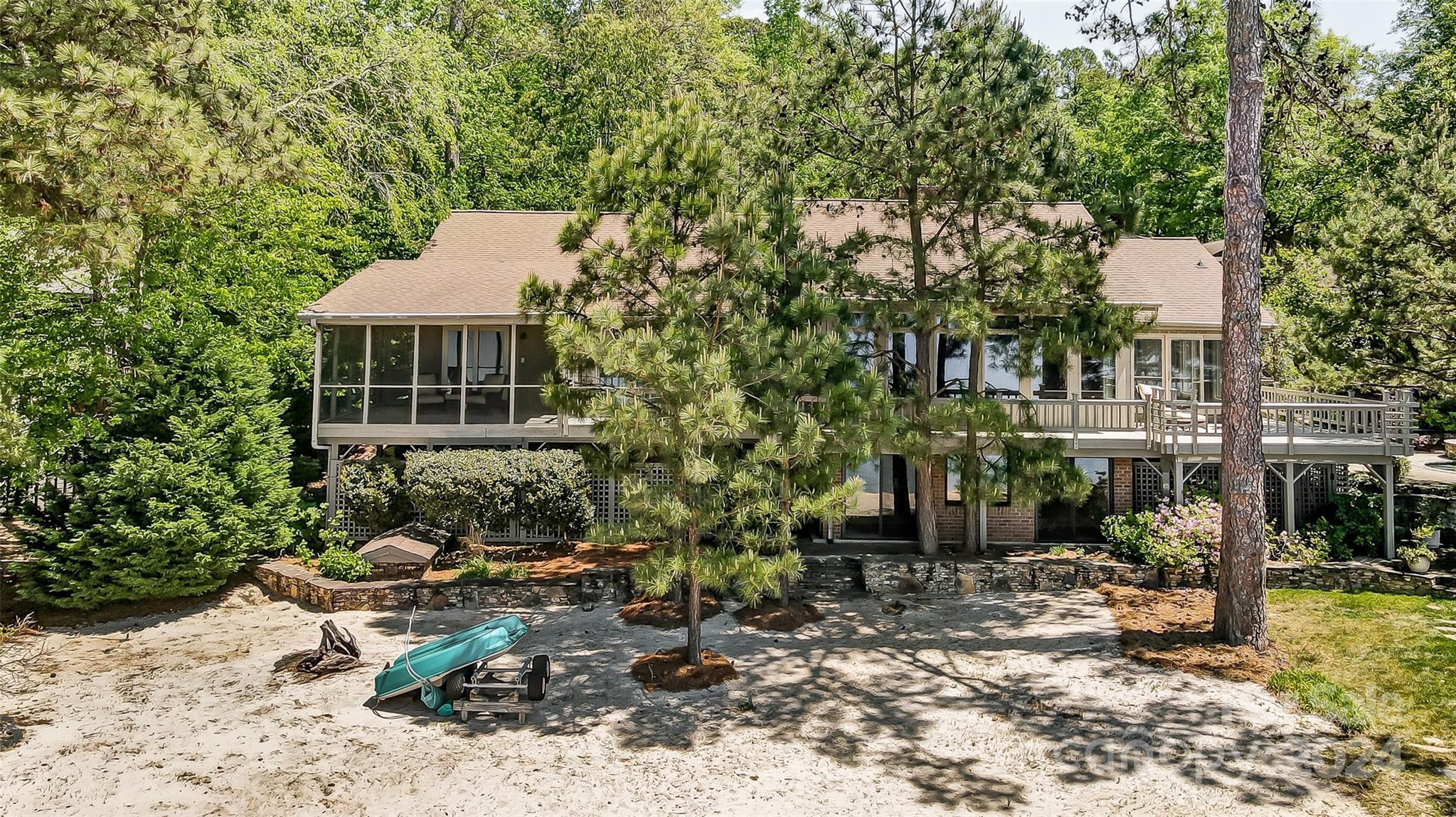 Lake living at its finest in River Hills! Welcome to a hard-to-find, west facing lake front home providing spectacular sunsets. Gorgeous views throughout the home, your own sandy beach area, lovely heated pool & spa, 2 screened porches, extensive wrap-around decking, built-in fire pit all overlook Lake Wylie. High ceilings, abundance of windows and skylights make the home always feel airy & bright. Beautiful, spacious great room & dining area have stunning views. Large kitchen with ample island work & eating space, Sub-Zero refrigerator, 6-burner+griddle & heat lamps Thermador Professional gas stove. A comfortable keeping room with fireplace adjoins the kitchen. Primary BR suite & 3 add’l BRs are all on the main level. Oversized rec room & full bath are in the walk-out basement, convenient to the beach area.  Beautifully landscaped nearly half acre lot. PREVIOUS OWNERS HAD AN APPROVED DOCK PLAN.  NEW OWNERS WOULD NEED TO COMPLETE A NEW APPLICATION WITH THEIR PLAN FOR APPROVAL