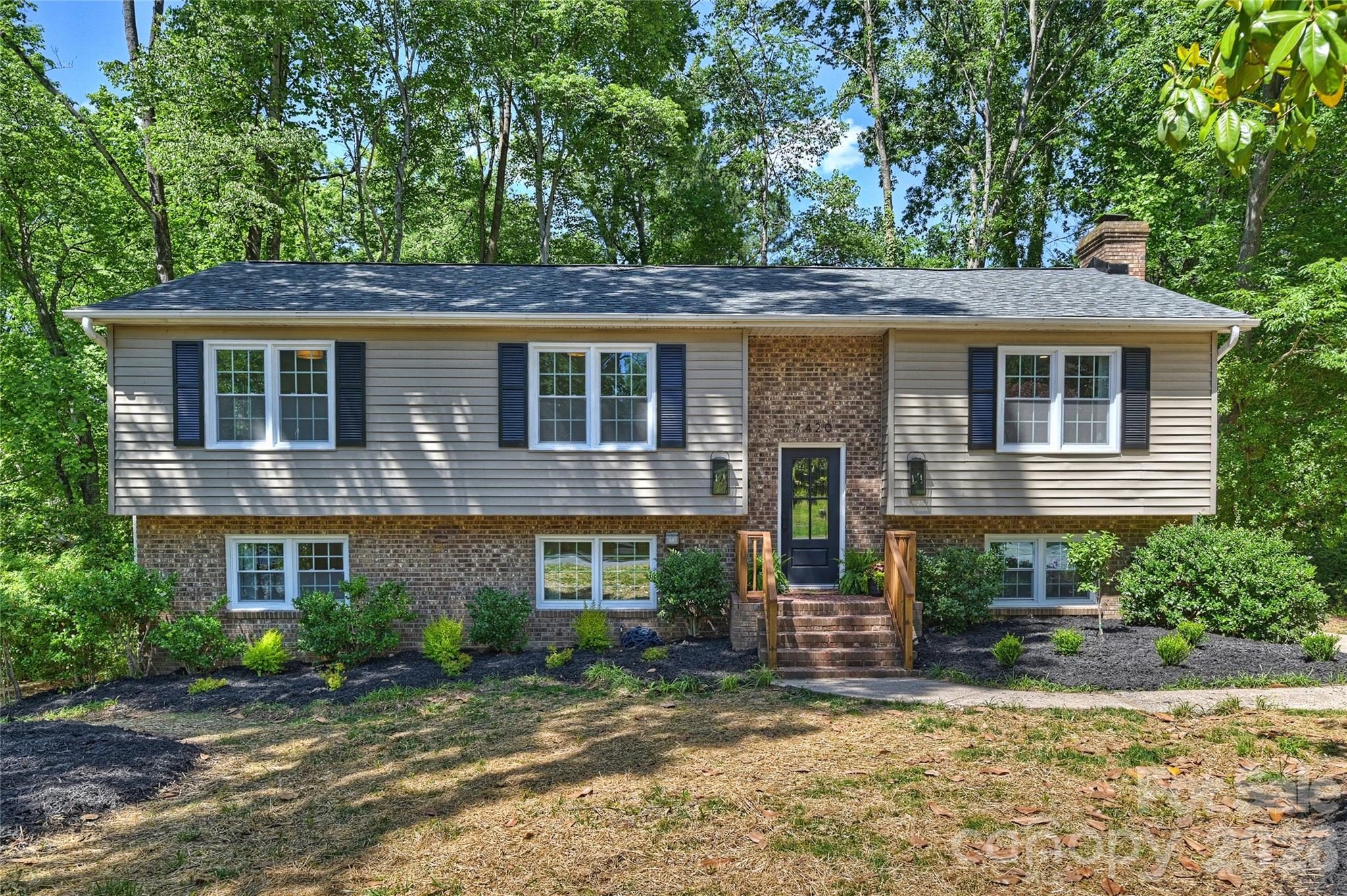Completely remodeled and ready to impress, this stunning home offers 4 bedrooms, 3 full baths, and a seamless blend of style and functionality. From the moment you step inside, you’ll be captivated by the open floorplan, designed to make both daily living and entertaining a breeze. The heart of the home is the chef’s kitchen, boasting a spacious island, sleek quartz countertops, brand-new stainless steel appliances, and a dining space with built-ins that provide ample storage. The main level features three beautifully appointed bedrooms and two full baths, each showcasing chic, on-trend vanities that add a touch of modern elegance. Upstairs, one of the bedrooms includes an ensuite bath—perfect for guests or a second primary. Downstairs, the second living area exudes charm with its moody palette and cozy fireplace, the perfect spot to relax and unwind. The expansive primary suite is a true sanctuary, complete with a large walk-in closet, a stunning ensuite bath featuring a fluted dual-sink vanity, a glass walk-in shower, and an adjacent flex space ideal for a home office or gym. Step out onto the serene deck overlooking a peaceful, wooded backyard that feels like your own mountain escape. Whether you’re sipping your morning coffee or unwinding in the evening, this outdoor space is pure tranquility. Nestled in the established Heritage Woods neighborhood, this home is centrally located between Matthews and Cotswold and just minutes from Uptown Charlotte. Plus, it’s in the coveted Private School Corridor, close to some of the city’s top-rated schools. With fully updated finishes, thoughtful design, and an unbeatable location, this home offers incredible value for modern living in Charlotte. Don’t miss your chance to make it yours!