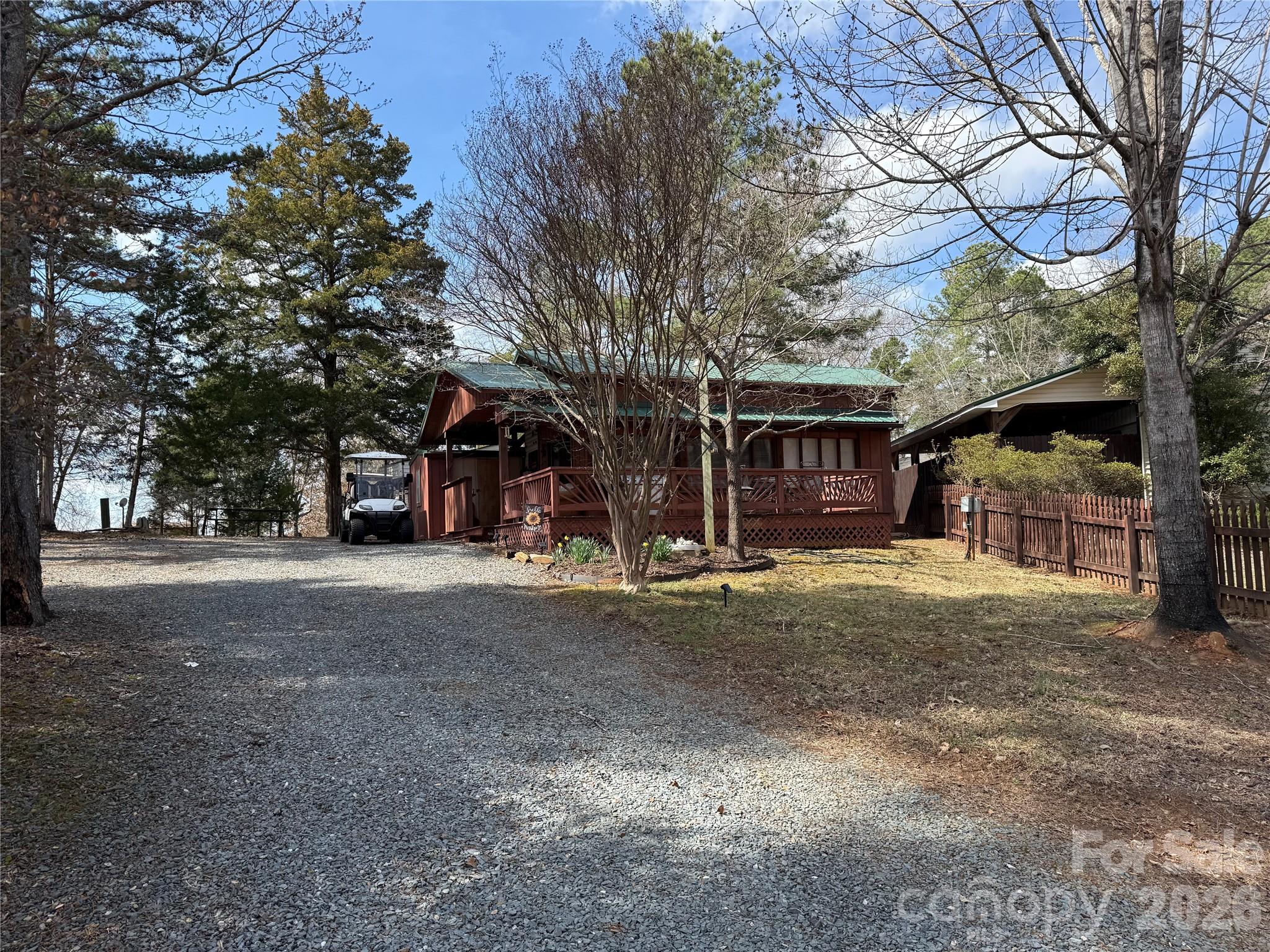 Welcome to 102 Doe Ct. This unit has a great oversized single lot. This 1985 Mallard Park Model is 38' long has a brand new shiplap ceiling through the unit and New LPV floors. The park model has the bedroom and the living room of park model has an additional bed and couch. 32' addition includes a spacious living room with table, 2 recliners, a couch and a bed. 2 mini splits to keep you comfortable year round. Plenty of sleeping. All electric unit. House size water heater. The walls that is half plexiglass in the living room gives this unit the feel of being outside while still enjoying the climate controlled house. 2 storage rooms and a covered storage area out back. One storage room has power and an additional refrigerator. Everything that is there is to remain except the ICON golf cart.  Includes an Ez-Go golf cart. Come and see if this could be your "Happy Place" here in the park. All buyers must be with a realtor to gain entry into the community.
