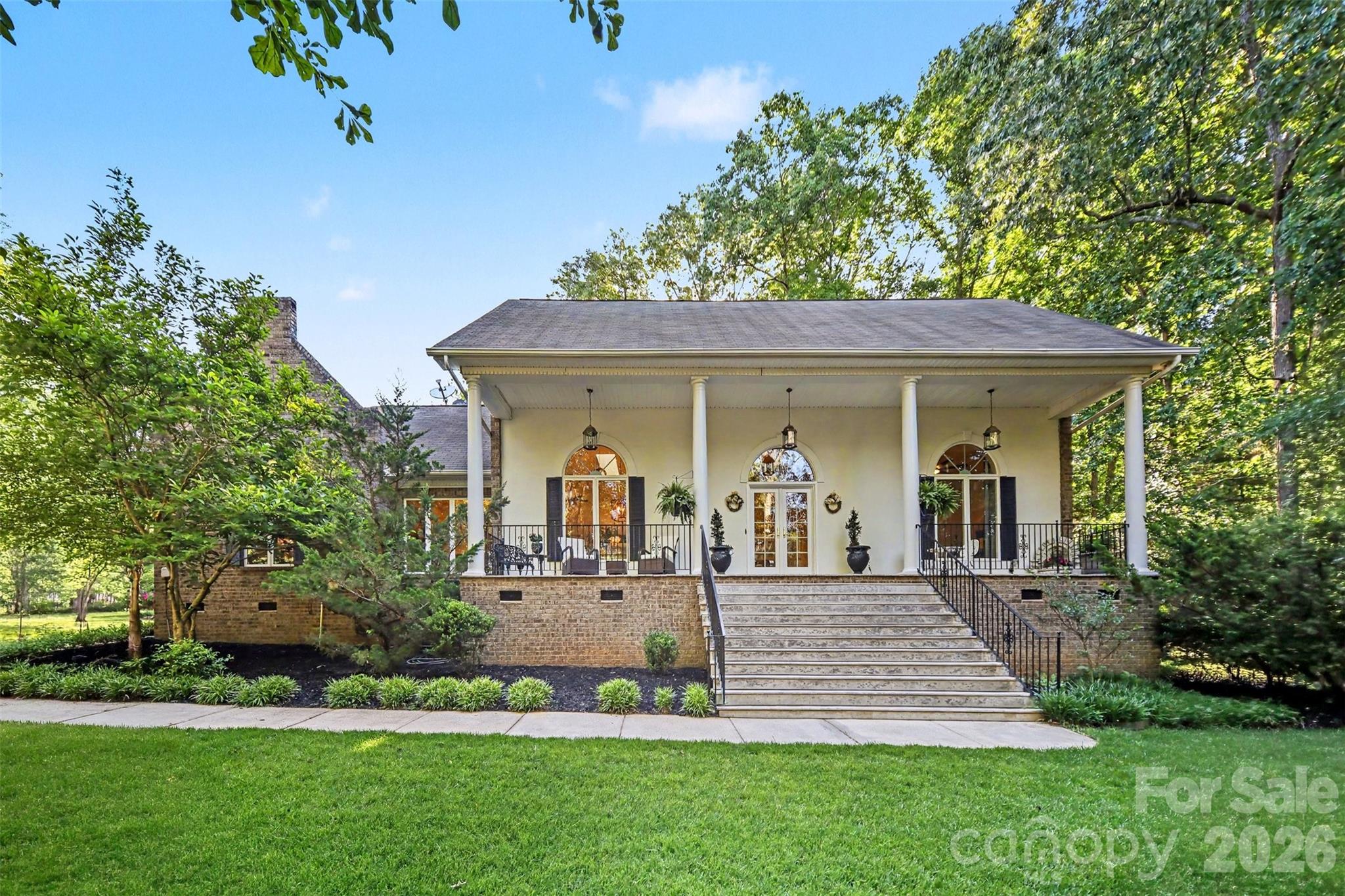 WATCH VIDEO TOUR FOR FULL WALKTHROUGH - Escape to your own private retreat on 5 breathtaking acres in Waxhaw, where peace, privacy, and natural beauty surround you at every turn. Tucked behind a personal gated entrance and nestled among mature trees, this beautifully updated ranch offers the perfect balance of relaxation and refined country living. Multiple outdoor living spaces including expansive decks, a screened-in porch, side patio, firepit area, and tranquil water feature with koi pond create a true backyard oasis designed for unwinding, entertaining, and enjoying the serene views year-round. Inside, the home has been thoughtfully remodeled with an open layout, soaring ceilings, designer finishes, and large windows that bring the outdoors in. The detached 2 bay garage/workshop is perfect for hobbyists with electricity, custom cabinetry, shelving, and a built-in compressor line all conveying with the property + a 50-amp RV hookup! Above the garage features a fully finished second living quarters complete with its own kitchen, living area, bedroom, bath, laundry, and private entrance—ideal for guests, multi-generational living, or potential rental income. Whether enjoying your morning coffee overlooking the peaceful landscape or hosting friends and family year round, this property offers a lifestyle that feels miles away while still being conveniently located near Waxhaw, Monroe, and Indian Land.
