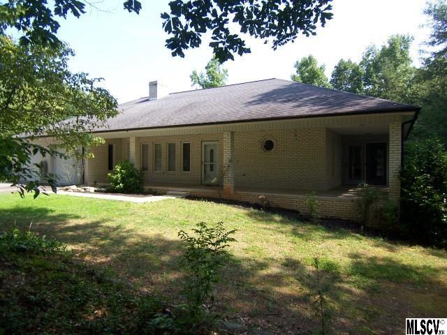 All brick, maintenance free, one level living. Close to lake. Minutes to Hwy 321. Convenient to Hickory. House is nestled in wooded setting. Open floor plan with fireplace and cathedral ceilings. Kitchen has breakfast bar, solid surface counters, and lots of cabinet space. House is designed with split bedroom plan. Lrg master bathroom w/garden tub, dbl sinks and separate shower.Walk-in closet. Relax in the sunroom just off master suite. Enjoy outdoor living on the 40 ft front porch and spacious back deck. Owners are ready to sell and have priced this house $54,000 below tax value!