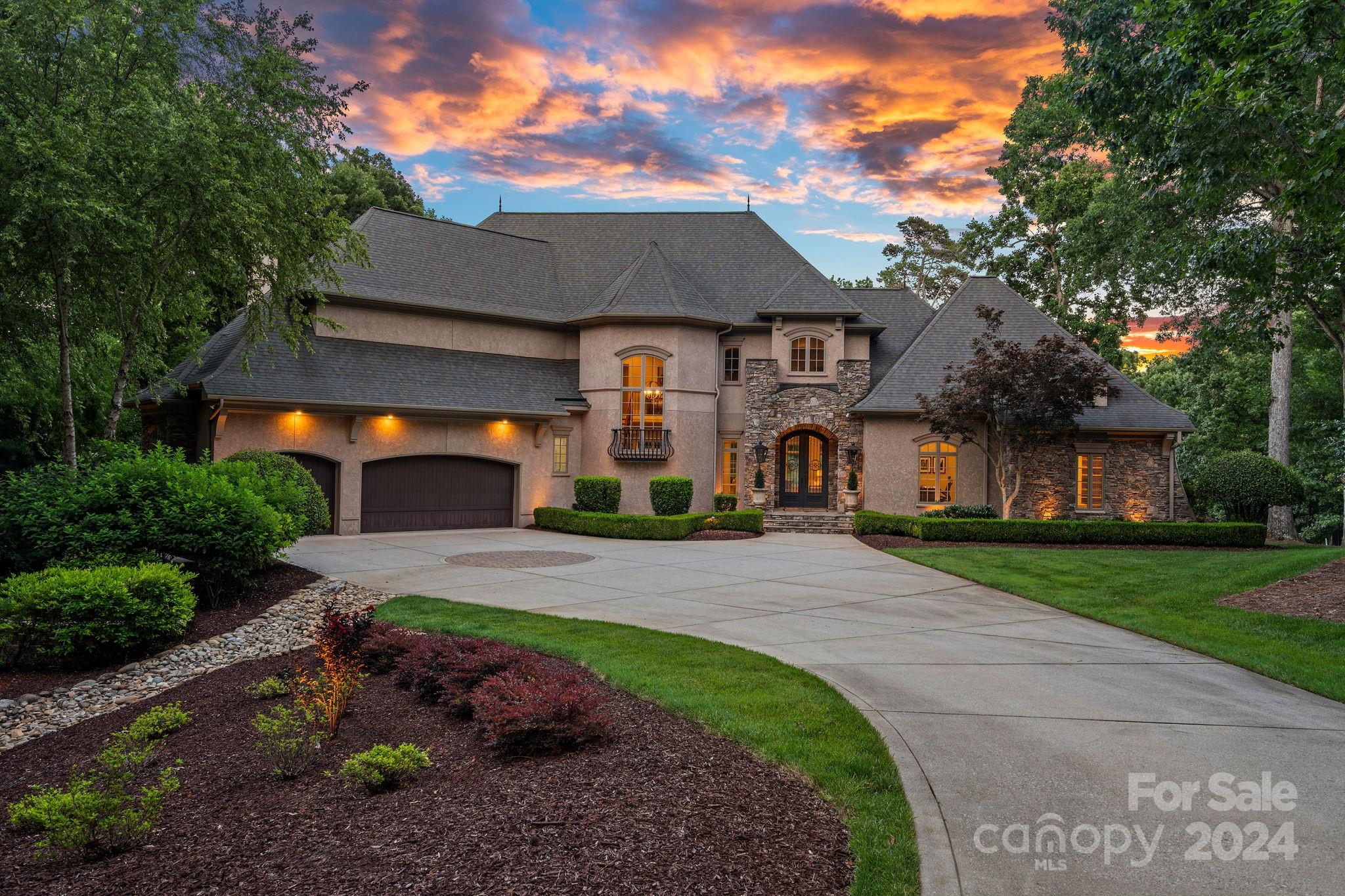 This exquisite luxury home, built by Augusta Home in The Point, offers stunning views of Lake Norman and the 8th tee and 7th green of Trump National Golf Club Charlotte. Every detail has been meticulously cared for, ensuring a captivating experience with lake views from most rooms. The home features a screened-in porch with a gas fireplace for perfect relaxation. The updated chef's kitchen, equipped with luxury appliances and a butler's pantry overlooking the porch, makes entertaining a delight. The main level owner's retreat is a spa-like haven with new fixtures and a remodeled closet. The grand staircase leads to the second level, an entertainer's paradise with a billiards room, bar, and media room. A secondary primary suite on this level includes a balcony with lake views. The unfinished basement is ideal for storing recreational toys or a golf cart and includes a half bath for backyard entertaining. Additionally, a deeded boat slip is just a short distance away.